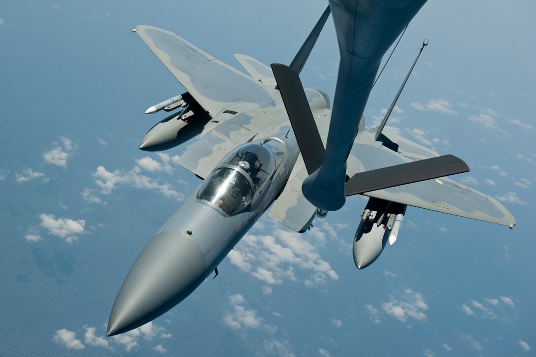A U.S. Air Force F-15C Eagle aircraft with the 44th Fighter Squadron approaches a KC-135 Stratotanker from the 909th Air Refueling Squadron to begin an inflight refueling procedure, March 21, 2016, off the coast of Japan. The 44th FS and 909th ARS conducted an inflight refueling exercise to demonstrate how tanker support can extend and prolong flight operations for U.S. and coalition aircraft. (U.S. Air Force photo by Senior Airman Peter Reft/Released)