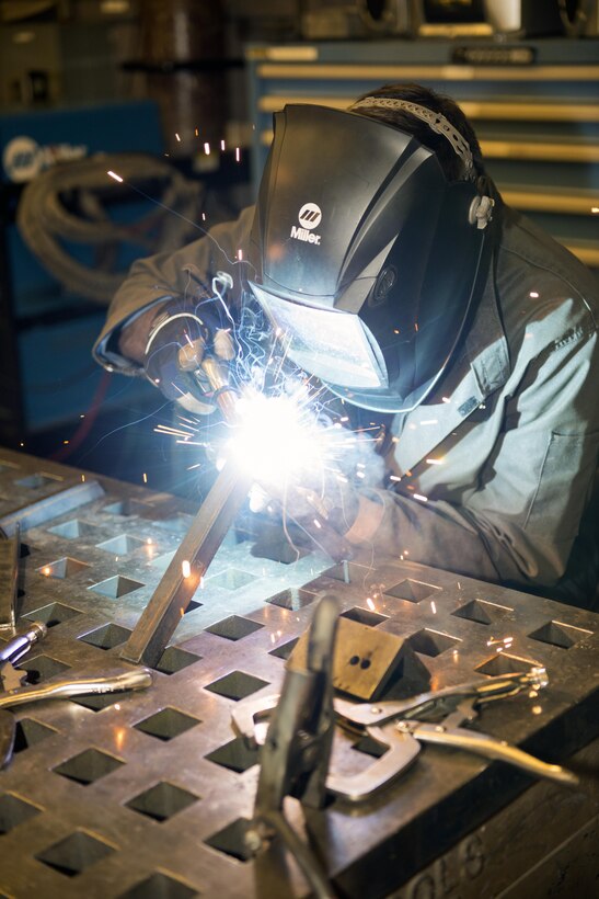 U.S. Air Force Airman 1st Class Joshua Tears-Knapp, 23d Equipment Maintenance Squadron aircraft metals technology journeyman, uses a metal inert gas welder to fabricate a bracket, March 18, 2016, at Moody Air Force Base, Ga. Metals technology technicians support perform 3,000 fabrication and repair jobs annually in support of approximately 70 aircraft and nearly 700 aerospace ground equipment units on base. (U.S. Air Force photo by Airman 1st Class Greg Nash/Released) 