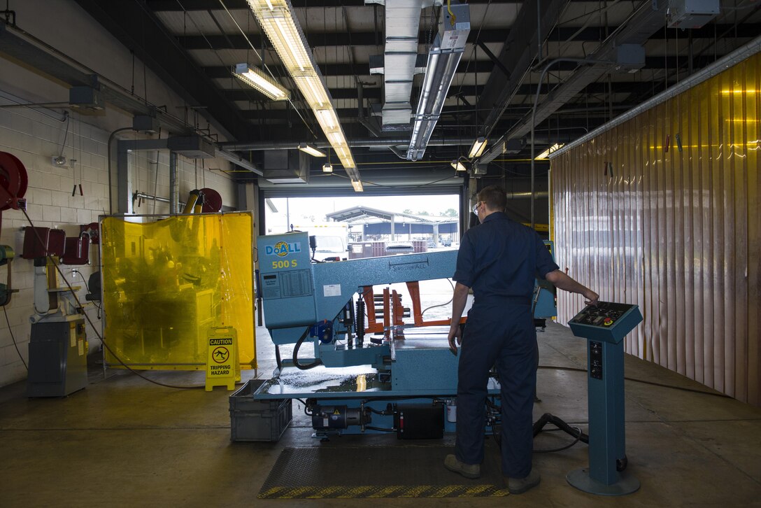 U.S. Air Force Airman 1st Class Joshua Tears-Knapp, 23d Equipment Maintenance Squadron aircraft metals technology technician, watches a horizontal bend saw cut steel, March 18, 2016, at Moody Air Force Base, Ga. Metals technology technicians must abide by the welding and machinery measuring tolerance of three thousandths of an inch, which is approximately the width of a human hair. (U.S. Air Force photo by Airman 1st Class Greg Nash/Released)  