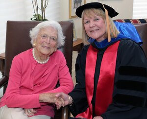 NIU Provost Dr. Susan Studds shakes hands with former First Lady Barbara Bush