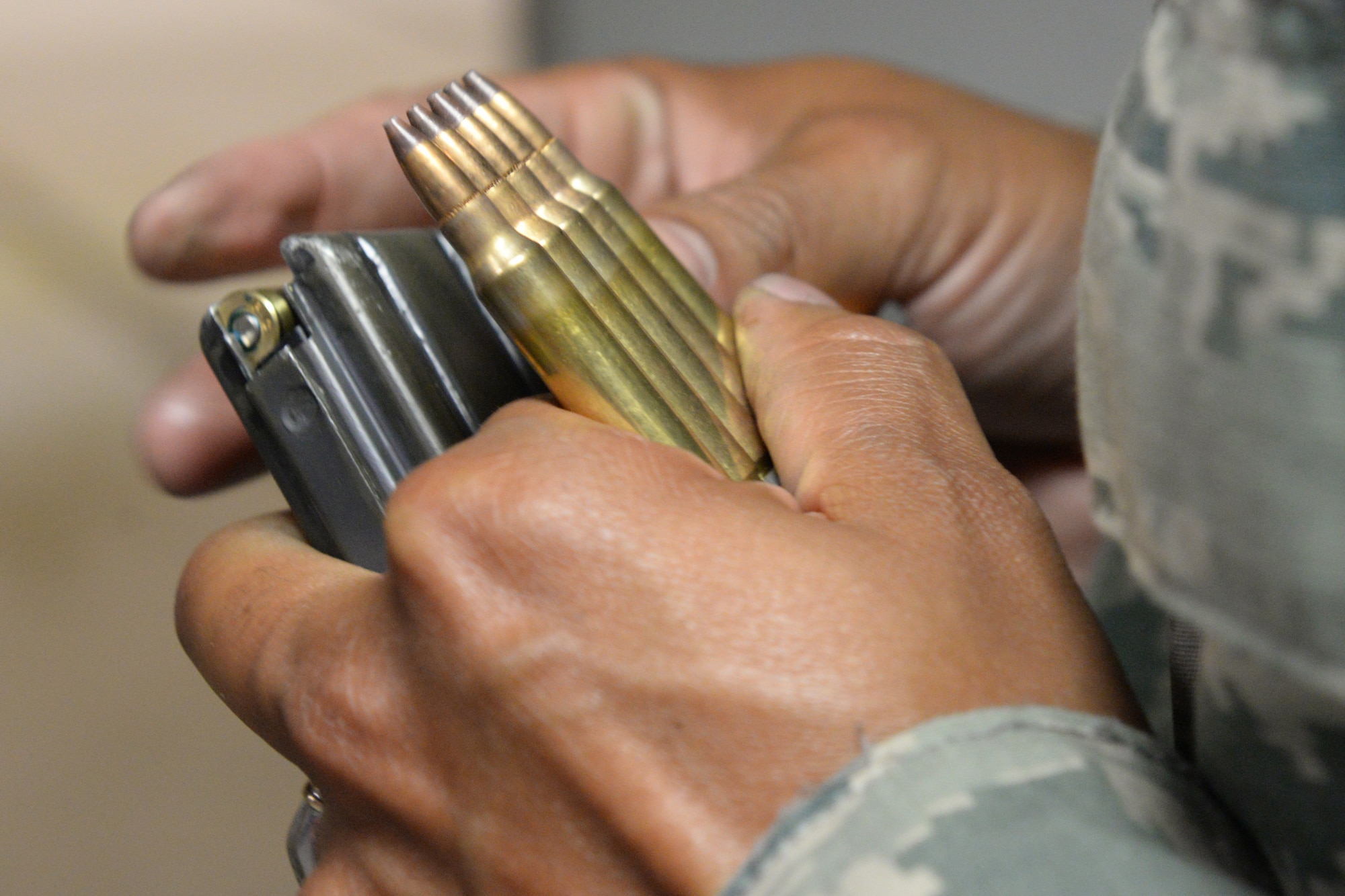 Master Sgt. Leslie Finley, 81st Logistics Readiness Squadron first sergeant, reloads 5.56 mm rounds into his magazine at the Combat Arms Training and Maintenance building March 9, 2016, Keesler Air Force Base, Miss. Before being deployed, Airmen must pass weapons qualifications with the M4 Carbine and be able to shoot from four positions – prone supported, prone unsupported, kneeling supported and over barricade supported – and hit their target from as far as 300 meters away. (U.S. Air Force photo by Airman 1st Class Travis Beihl)