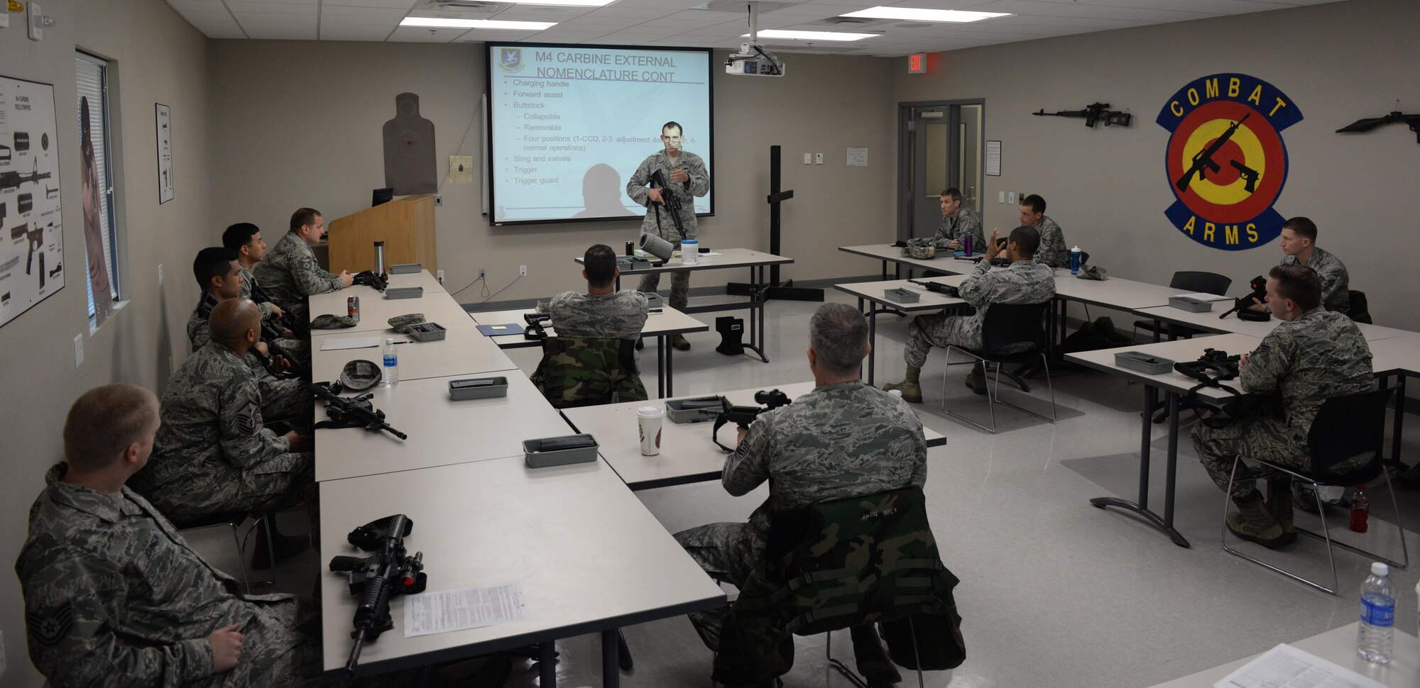 Staff Sgt. Joshua Green, 81st Security Forces Squadron combat arms instructor, instructs a class at the Combat Arms Training and Maintenance building March 9, 2016, Keesler Air Force Base, Miss. During classroom instruction, Airmen receive refresher training on how to properly handle, load, fire and maintain weapons ranging from the M4 Carbine to the Beretta M9. (U.S. Air Force photo by Airman 1st Class Travis Beihl) 