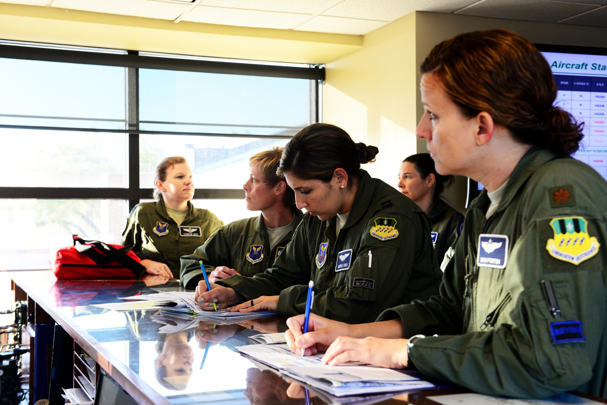 An all-female aircrew is briefed before their flight at Barksdale Air Force Base, La., March 22, 2016. To celebrate women’s history month, two all-female aircrews were assembled to make U.S. Air Force history by being the first all-female aircrew to fly a B-52 Stratofortress. (U.S. Air Force photo/Airman 1st Class Luke Hill)