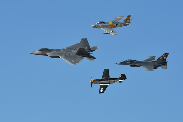A Heritage Flight formation flies over show center during the 2016 Heritage Flight Training Course demonstration at Davis-Monthan Air Force Base, Ariz., March 5, 2016. The Heritage Flight Training Course allows pilots assigned to the three Air Combat Command demonstration teams to practice their demonstrations with the Heritage Flight pilots, displaying a formation of modern and historic aircraft. (U.S. Air Force photo by Senior Airman Diana M. Cossaboom)