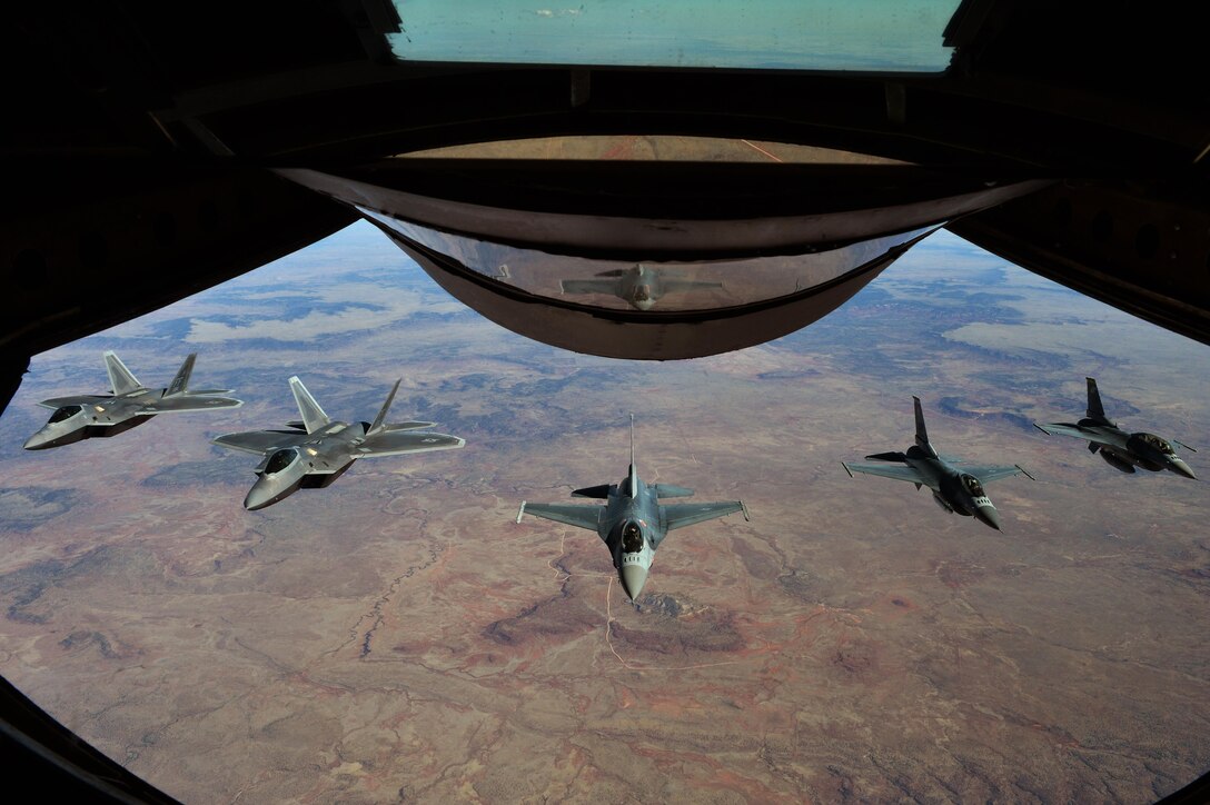 Two F-22 Raptors and three F-16 Fighting Falcons fly behind a KC-135 Stratotanker on their way to the 2016 Heritage Flight Training Course at Davis-Monthan Air Force Base, Ariz., March 2, 2016. Air Combat Command supports three demonstration teams that perform world-wide displaying the combat ready air power of the U.S. Air Force. (U.S. Air Force photo by Senior Airman Diana M. Cossaboom)