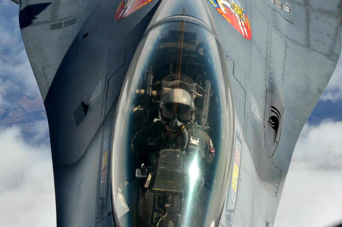 U.S. Air Force Maj. Craig “Rocket” Baker, F-16 Viper Demonstration Team pilot, looks up while refueling on his flight to the 2016 Heritage Training Course at Davis-Monthan Air Force Base, Ariz., March 2, 2016. Baker, beginning his second year on the demo team, has more than 2,000 flying hours in jet aircraft. (U.S. Air Force photo by Senior Airman Diana M. Cossaboom)