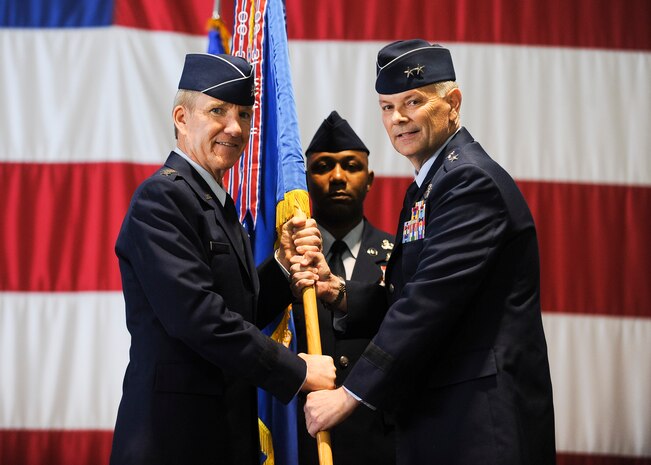 Maj. Gen. Glen VanHerck (right) assumes command of the U.S. Air Force Warfare Center from Gen. Hawk Carlisle, commander Air Combat Command , during a change of command ceremony at the Thunderbirds hangar at Nellis Air Force Base, Nev., March 22. The USAFWC exists to ensure deployed forces are well trained and well equipped to conduct integrated combat operations. From testing and tactics development programs to training schools and venues, the USAFWC provides Airmen with proven and tested technology, the most current tactics, superb academic training and a unique opportunity to practice integrated force employment. (U.S. Air Force photo by Senior Airman Jake Carter)