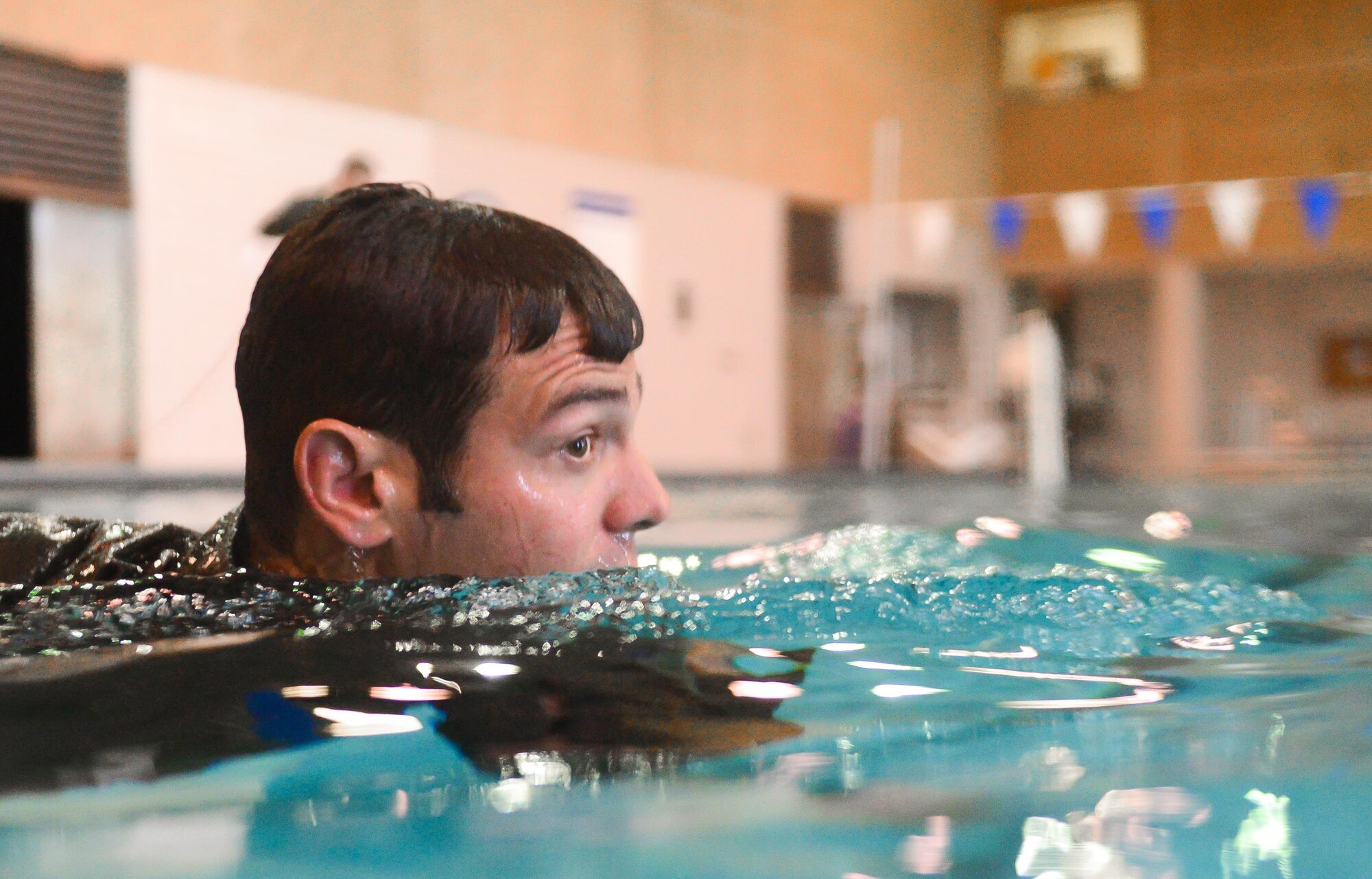 Staff Sgt. Matthew Mete, 2nd Operations Support Squadron Survival, Evasion, Resistance and Escape specialist, swims towards a simulated obstacle during a water survival class in Shreveport, La., March 15, 2016. Aircrew trained with a variety of rescue devices, from flotation devices to Coast Guard rescue baskets. Using real world devices provided aircrew the most authentic training available in a safe environment. (U.S. Air Force photo/Senior Airman Mozer O. Da Cunha)