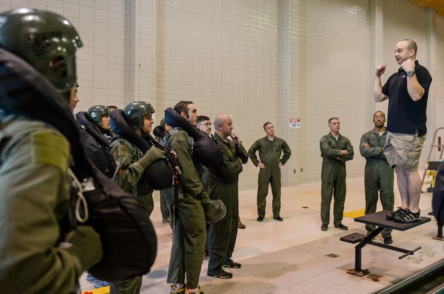 Tech. Sgt. Michael Slaton, 2nd Operations Support Squadron Survival, Evasion, Resistance and Escape specialist, instructs aircrew during water survival training in Shreveport, La., March 15, 2016. Slaton gave aircrew steps to escape from underneath a parachute canopy after ejecting into a body of water. (U.S. Air Force photo/Senior Airman Mozer O. Da Cunha)