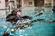 Staff Sgt. Matthew Mete, 2nd Operations Support Squadron Survival, Evasion, Resistance and Escape specialist, swims towards a life raft during a water survival class in Shreveport, La., March 15, 2016. Mete demonstrated the correct way to board a life raft without causing punctures or knicks. Aircrew deploy the life raft as part of a descend checklist after aircraft ejection. (U.S. Air Force photo/Senior Airman Mozer O. Da Cunha)