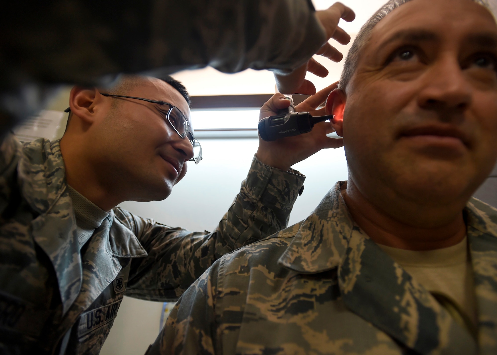 Senior Airman Jherico Guerrero, 559th Medical Group Public Health Technician, checks a patient’s ear prior to administering a hearing test at the Deployment Related Health Clinic, part of the 59th Medical Wing Base Operational Medicine Clinic at the Wilford Hall Ambulatory Surgical Center, Joint Base San Antonio-Lackland, Texas, Feb 24. The DRHC will see approximately 250 members a month for deployment health assessments. (U.S. Air Force photo/Staff Sgt. Kevin Iinuma)