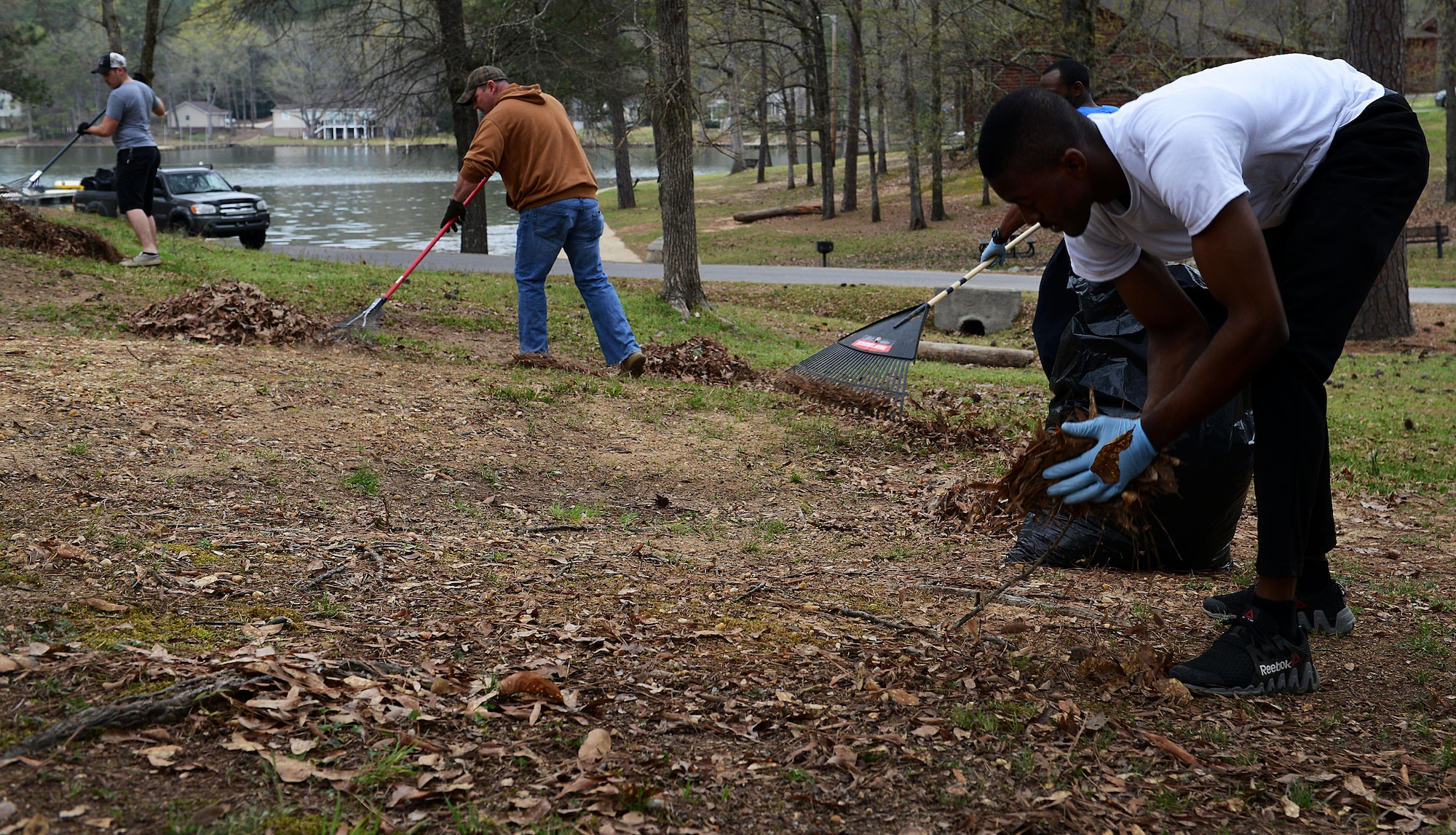 U.S. Airmen clean up debris at the 20th Force Support Squadron Wateree Recreation Area near Camden, S.C., March 19, 2016. The Wateree Recreation Area offers camping, fishing, and other recreational activities to service members and their families. (U.S. Air Force photo by Airman 1st Class Destinee Dougherty)