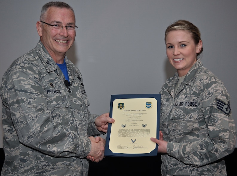 Commander of the 932nd Airlift Wing, Col. Jonathan Philebaum, brought Staff Sgt. Lyndi Keltner (and additional enlisted leaders) before the unit at a recent Illinois ceremony to present this certification of induction, recognizing the sergeant as another new noncommissioned officer in the Air Force Reserve Command. (U.S. Air Force photo by Staff Sgt. Amber Hodges)