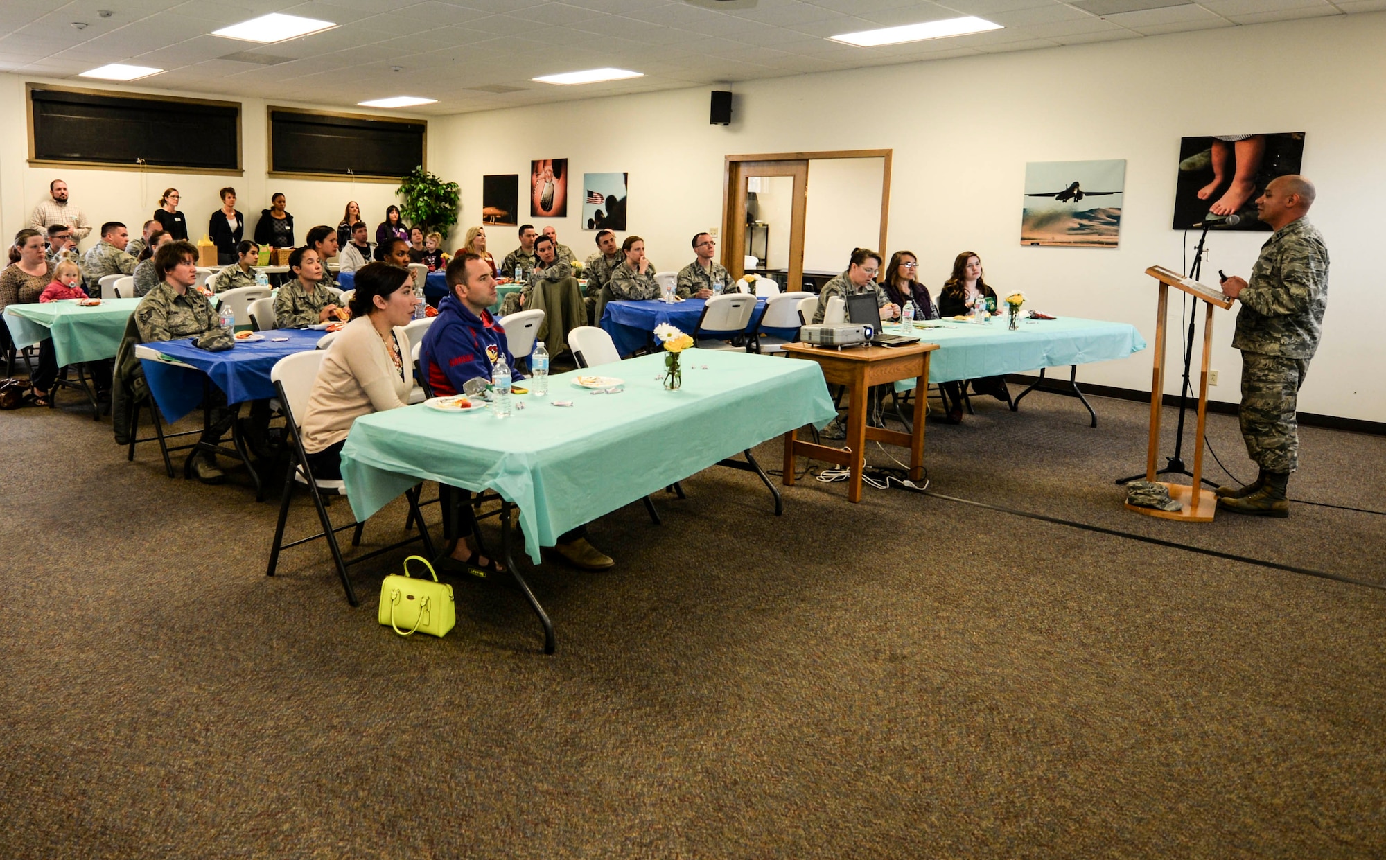 Chap. (Capt.) Benjamin Quintanilla, 28th Bomb Wing chaplain, speaks at the “Why not you?” campaign event at Ellsworth Air Force Base, S.D., March 15, 2016. During the campaign, several agency representatives spoke on the different foster care programs willing families can take part in, and ways they can adopt. (U.S. Air Force photo by Airman 1st Class Sadie Colbert/Released)