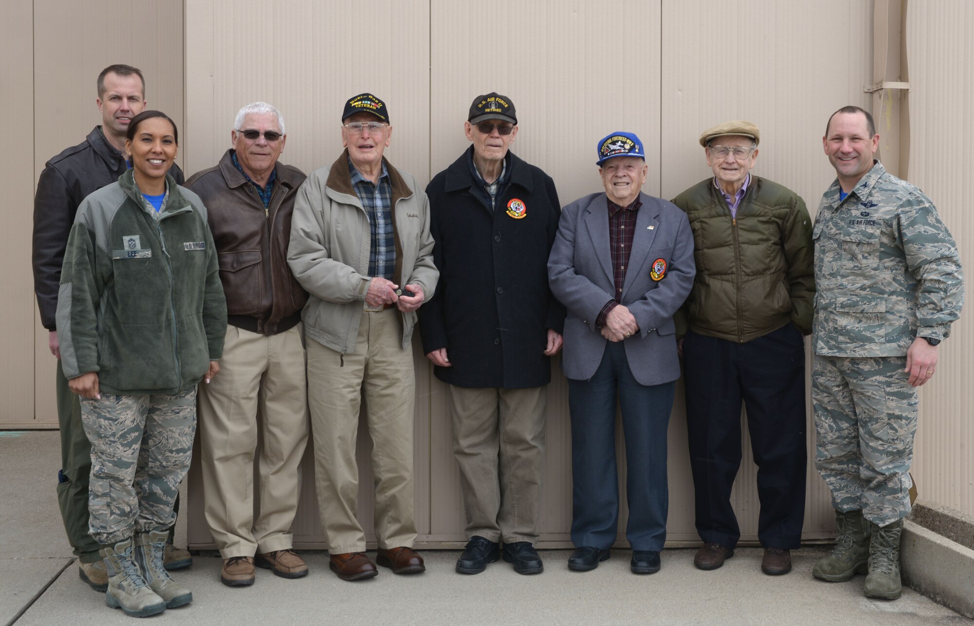 Ellsworth leadership poses with retired Army Air Corps veterans for a group photo outside of a B-1 bomber hangar at Ellsworth Air Force Base, S.D., March 18, 2016. Wing leadership took the veterans on a tour of the base while explaining the advancements of today’s warfighting aircraft, stopping to show them a B-1 in its hangar and watch a touch-and-go landing. (U.S. Air Force photo by Airman Donald Knechtel/Released)
