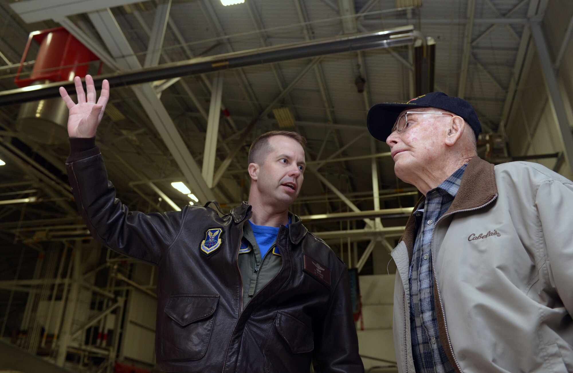 Col. Ty Neuman, 28th Bomb Wing vice commander, gives retired Col. Hilary Cole, former Army Air Corps pilot, a tour of a B-1 bomber hangar at Ellsworth Air Force Base, S.D., March 18, 2016. Neuman showed Cole and other veterans the B-1, explaining the advancements of bomber technology within the past 30 years. (U.S. Air Force photo by Airman Donald Knechtel/Released)