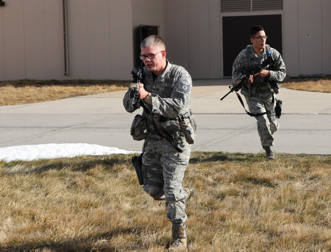 Tech. Sgt. Steven Groff, 28th Security Forces Squadron flight chief, and Airman 1st Class Christopher Dominguez, 28th SFS response force member, participate in a training exercise at Ellsworth Air Force Base, S.D., Feb. 10, 2016. Airmen of the 28th SFS engage in more than 200 hours of training annually, which include combative skills and law enforcement training. (U.S. Air Force photo by Airman 1st Class Denise M. Nevins/Released)