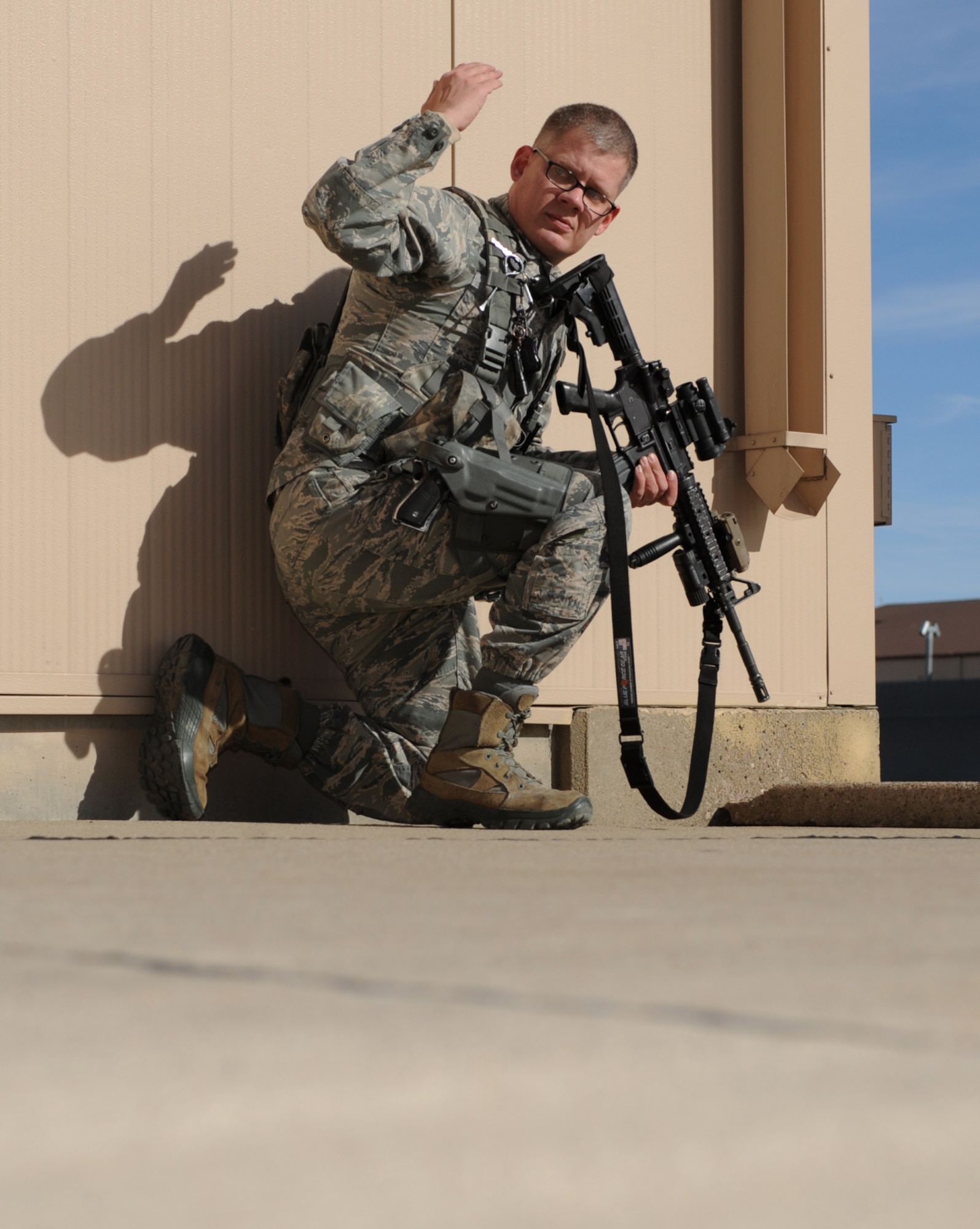 Tech. Sgt. Steven Groff, 28th Security Forces Squadron flight chief, signals for his partner to advance during a training exercise at Ellsworth Air Force Base, S.D., Feb. 10, 2016. Training exercises ensure defenders are ready to perform their duty at any time, whether at home or deployed. (U.S. Air Force photo by Airman 1st Class Denise M. Nevins/Released)