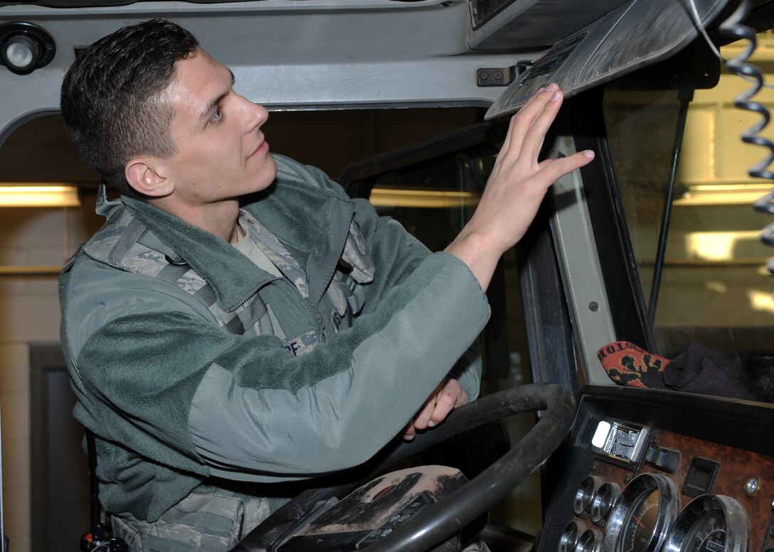 Airman 1st Class John Stumpf, 28th Security Forces Squadron response force member, inspects a commercial truck prior to authorizing entrance to Ellsworth Air Force Base, S.D., Feb. 10, 2016. Security forces personnel are the Air Force's first line of defense and it is their job to uphold the law on all Air Force installations. (U.S. Air Force photo by Airman 1st Class Denise M. Nevins/Released)