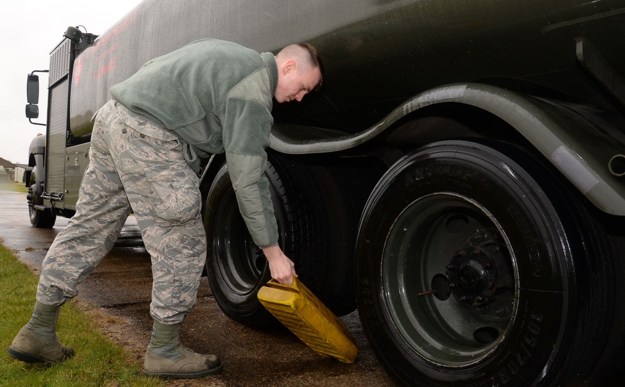 U.S. Air Force Airman 1st Class George Palmer, 100th Logistics Readiness Squadron mobile distribution operator, removes a chock prior to moving a fuel truck March 9, 2016, on RAF Mildenhall, England. R-11 refueling units like this hold 6,000 gallons of fuel and are used for smaller fuel requests. (U.S. Air Force photo by Gina Randall/Released)