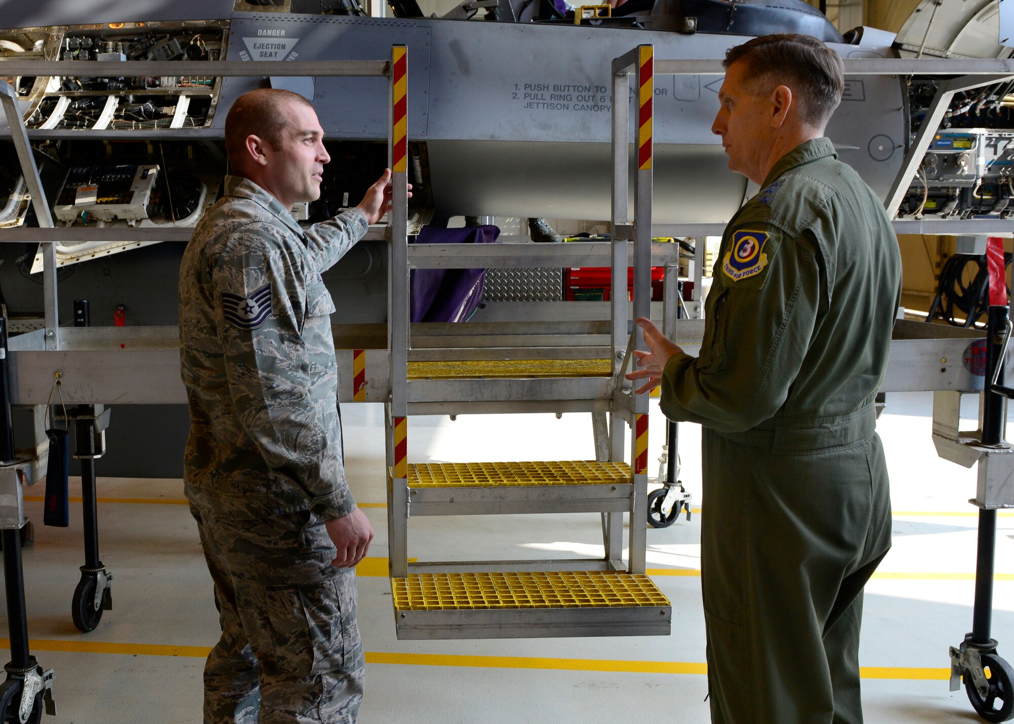 Tech. Sgt. Wesley Mull, 31st Maintenance Squadron phase dock chief, speaks with Lt. Gen. Timothy Ray, 3rd Air Force and 17th Expeditionary Air Force commander, March 21, 2016, at Aviano Air Base, Italy. In his first visit to Aviano, Ray toured the base, met with Airmen and hosted an all call to thank Team Aviano members for their proven track record of generating airpower at a moment’s notice. (U.S. Air Force photo by Senior Airman Krystal Ardrey/Released)