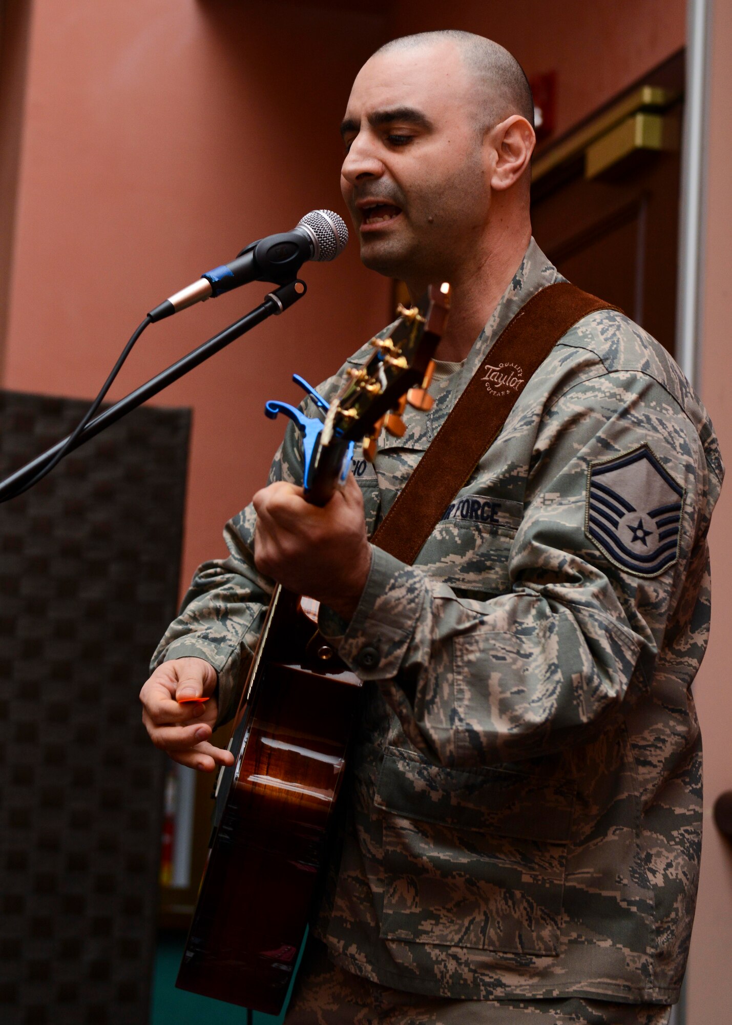 Master Sgt. Salvatore Capaccio, 31st Fighter Wing chapel appropriations superintendent, performs a bluesy hymn during a National Prayer Breakfast observance, March 21, 2016, at Aviano Air Base, Italy. The National Prayer Breakfast has taken place in Washington D.C. since 1953. (U.S. Air Force photo by Senior Airman Austin Harvill/Released)
