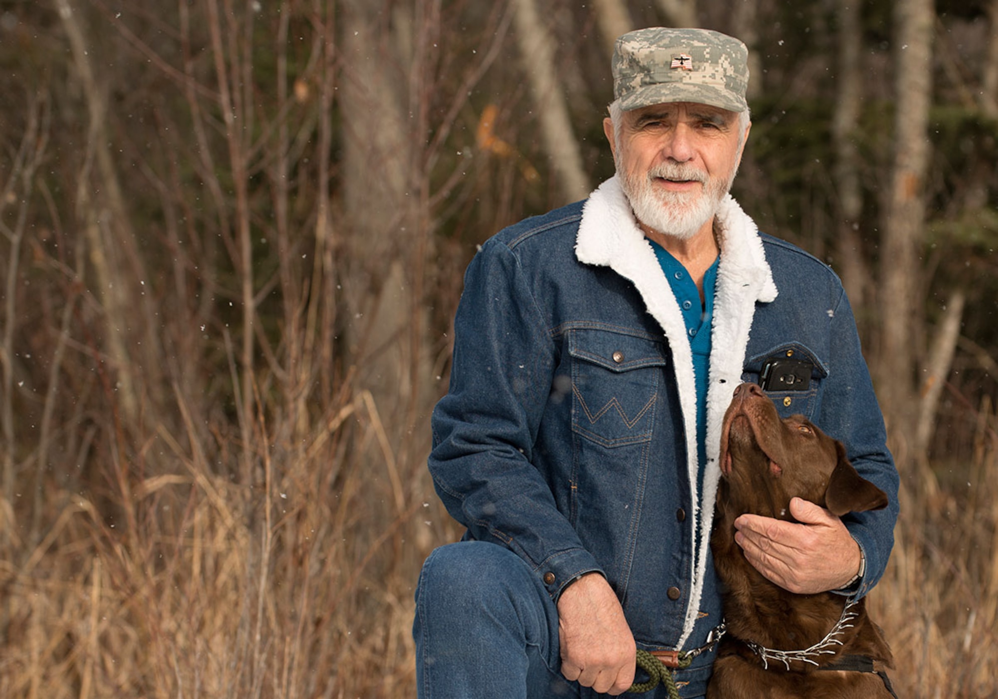 Ken Bylow, an Army veteran who served in Vietnam during the Tet Offensive, poses with his new service dog, Cowboy. Cowboy was given to him by a nonprofit organization after losing his previous service dog. During his time in Vietnam, Bylow earned a Bronze Star Medal with V for Valor. (U.S. Air Force photo by Airman 1st Class Kyle Johnson)