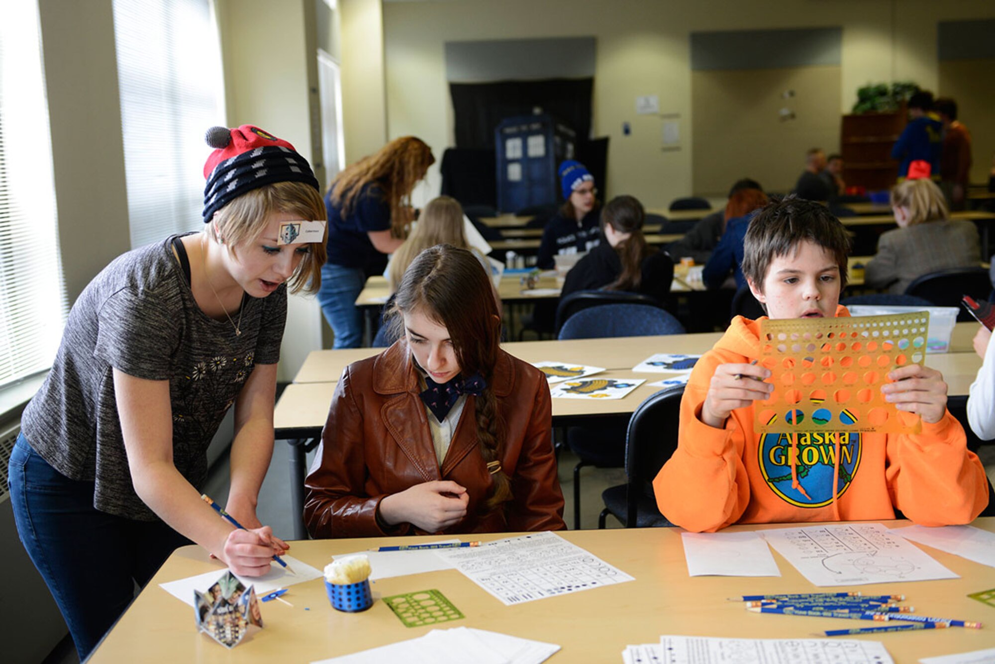 Teenagers take part in the arts and crafts offered during the Dr. Who Wibbly Wobbly Timey Wimey teen program at the Joint Base Elmendorf- Richardson Library, March 16, 2016. In addition to dressing in Dr. Who costumes, teens played games and made multiple crafts to take home. (U.S Air Force photo by Airman Valerie Monroy)