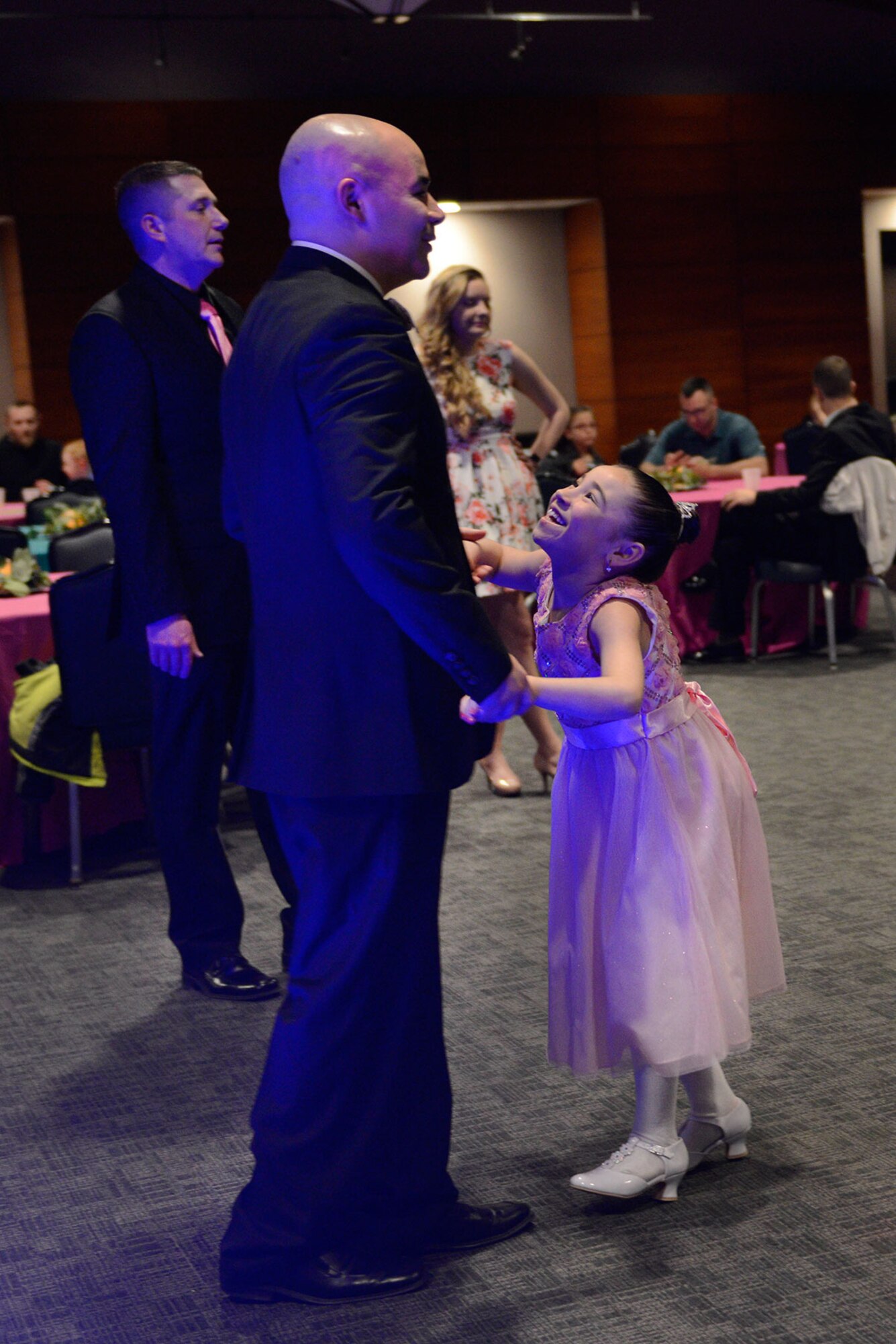 Air Force Master Sgt. Richard Duken, 962nd Airborne Air Control Squadron, dances with his daughter Alessandra Duken, 8, during the Father/Daughter and Mother/Son Dance at the Arctic Warrior Events Center March 18, 2016. The event was sponsored by the Family Advocacy Program, the Sexual Assault Prevention and Response Office, the chapel team, and the USO. (U.S. Air Force photo by Airman Valerie Monroy)