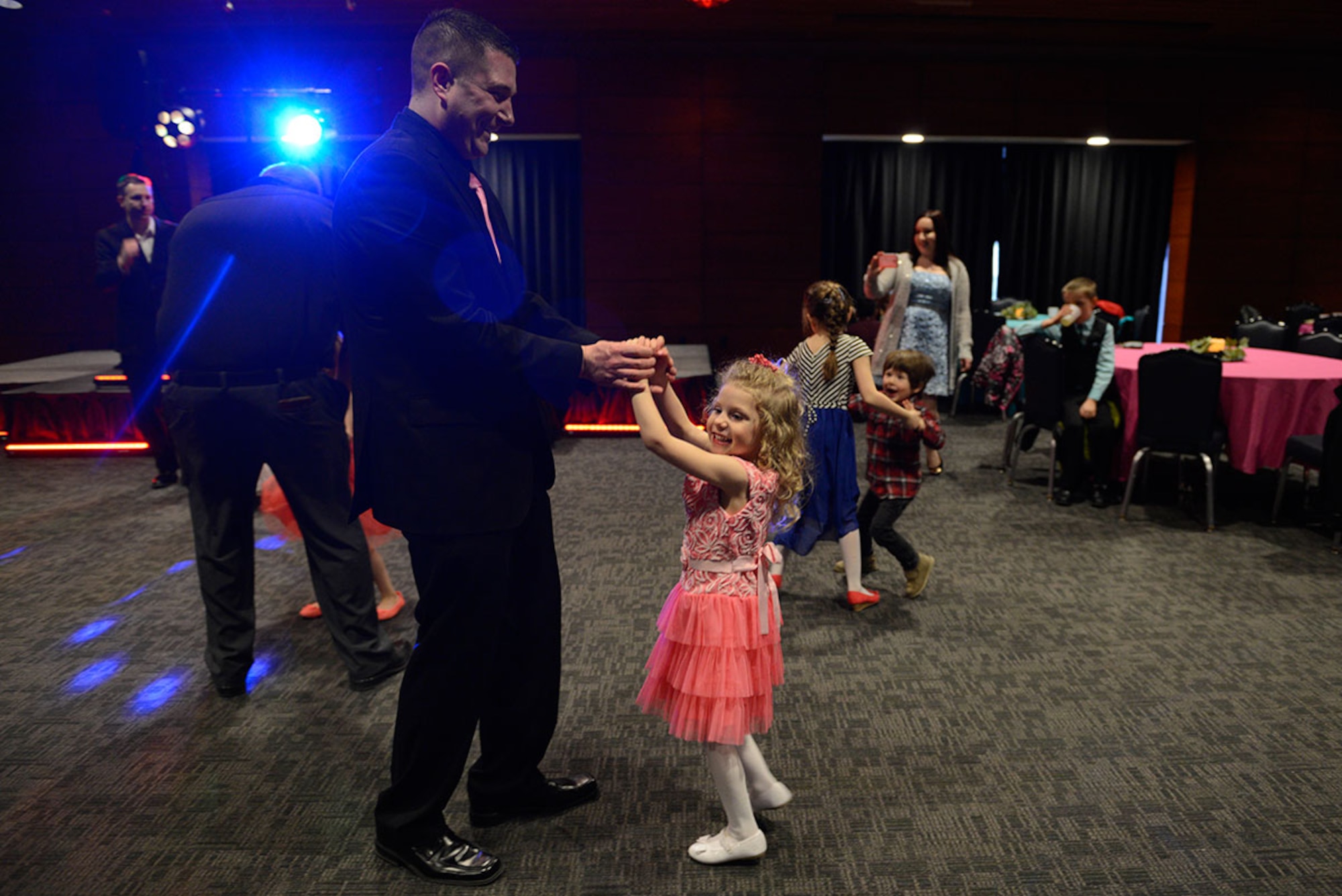 Air Force Master Sgt. Michael Granato, 3rd Operations Support Squadron, dances with his daughter Natalie Granato, 4, during the Father/Daughter and Mother/Son Dance at the Arctic Warrior Events Center March 18, 2016. The event allowed service members from all branches the chance to spend an evening connecting with their children. (U.S. Air Force photo by Airman Valerie Monroy)