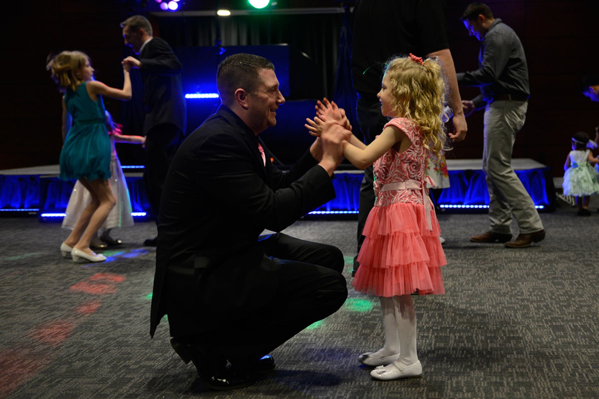Air Force Master Sgt. Michael Granato, 3rd Operations Support Squadron, dances with his daughter Natalie Granato, 4, during the Father/Daughter and Mother/Son Dance at the Arctic Warrior Events Center March 18, 2016. (U.S. Air Force photo by Airman Valerie Monroy)