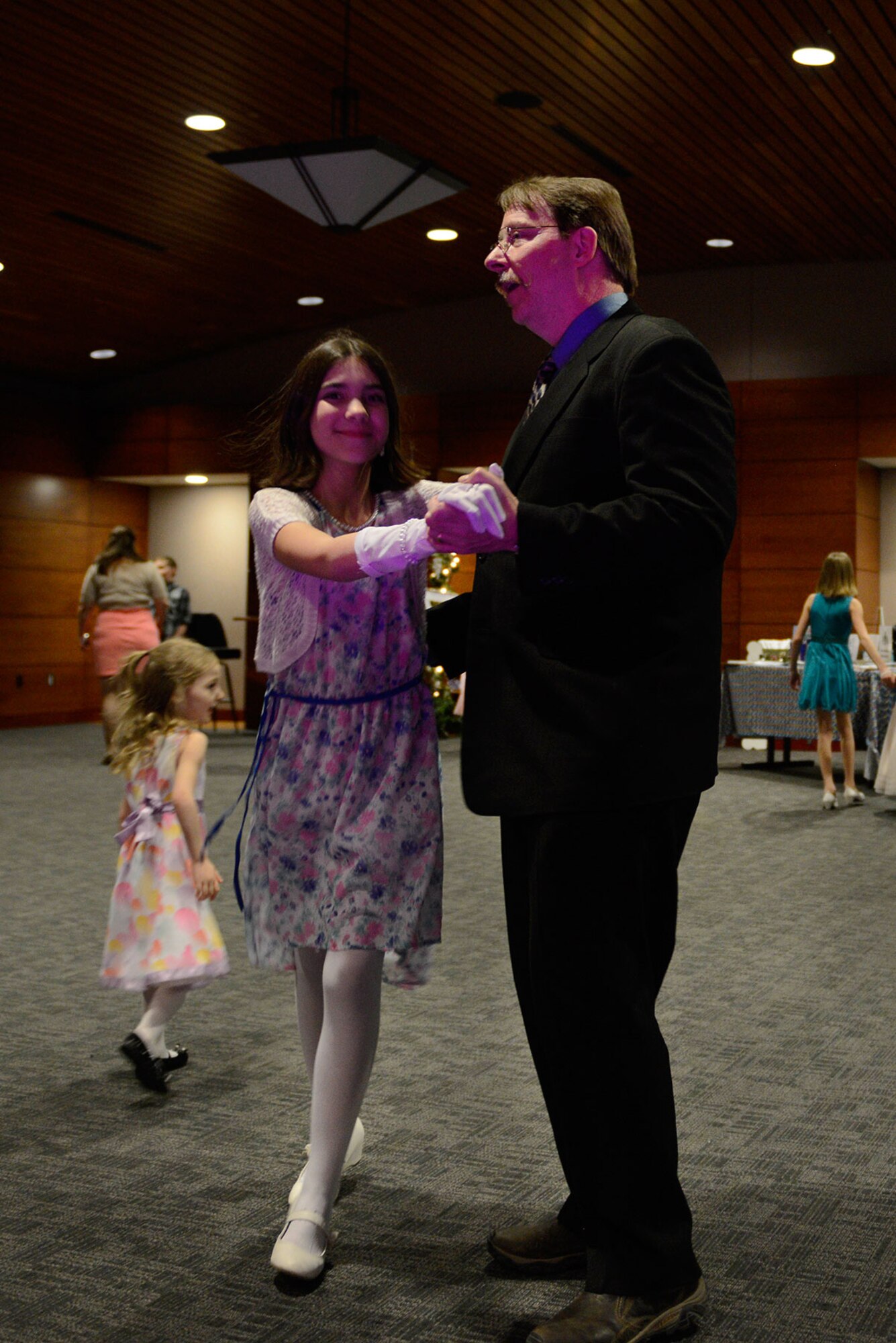 Paul Thiel, 673rd Force Support Squadron, dances with his daughter Joryan Thiel, 10, during the Father/Daughter and Mother/Son Dance at the Arctic Warrior Events Center March 18, 2016. The event was open to all families from Joint Base Elmendorf-Richardson. (U.S. Air Force photo by Airman Valerie Monroy)