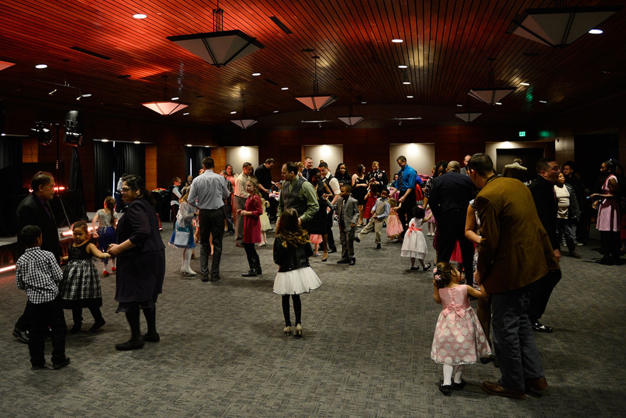 Parents dance with their children during the Father/Daughter and Mother/Son Dance at the Arctic Warrior Events Center March 18, 2016. The event was sponsored by the Family Advocacy Program, the Sexual Assault Prevention and Response Office, the chapel team, and the USO. (U.S. Air Force photo by Airman Valerie Monroy)