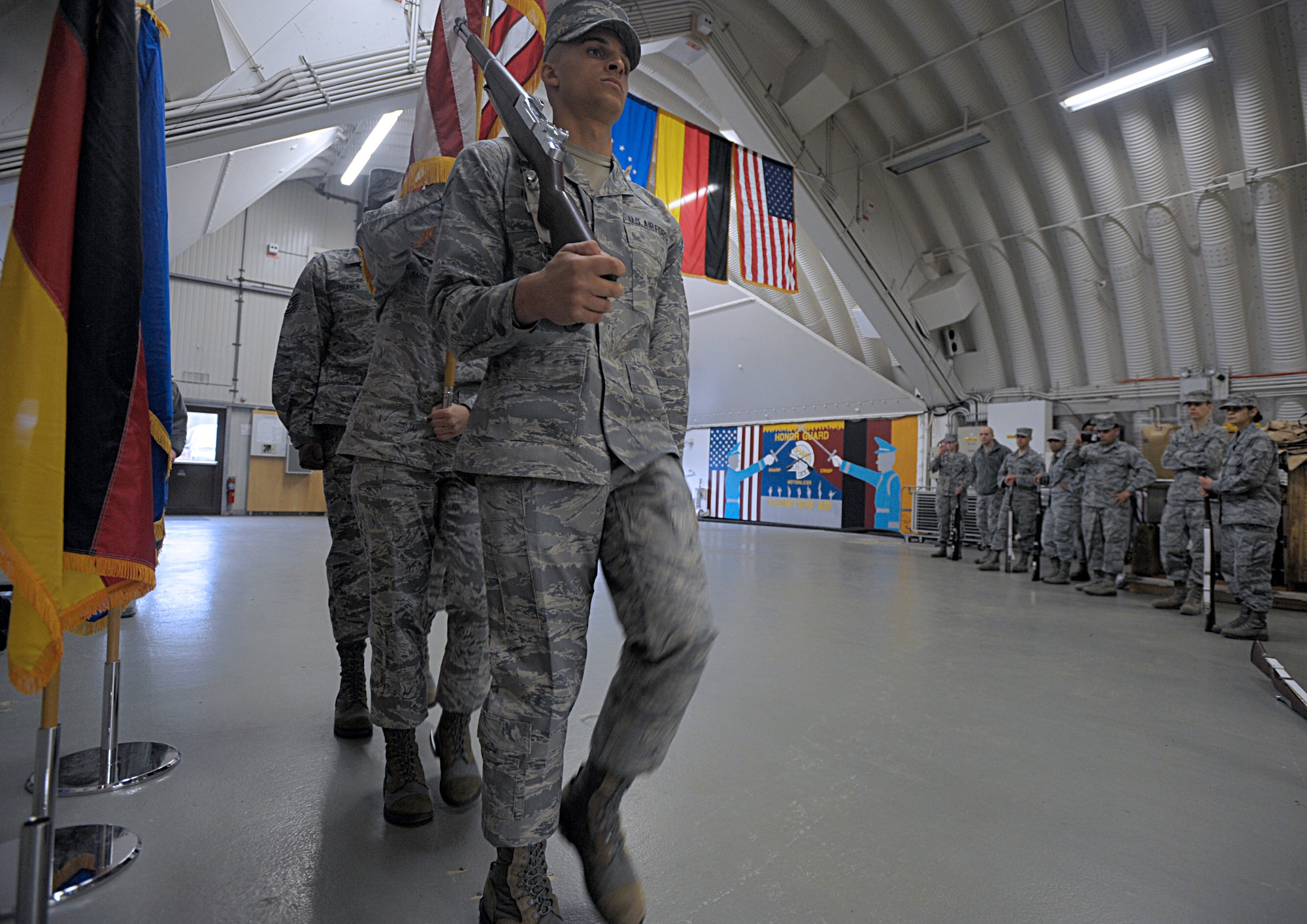 U.S. Air Force Honor Guard members demonstrate color guard movements to members of the Ramstein Honor Guard March 15, 2016, at Ramstein Air Base, Germany. Ramstein Honor Guard members got the opportunity to learn uniform preparation and color guard motions from U.S. Air Force Honor Guard members. (U.S. Air Force photo/Staff Sgt. Timothy Moore)
