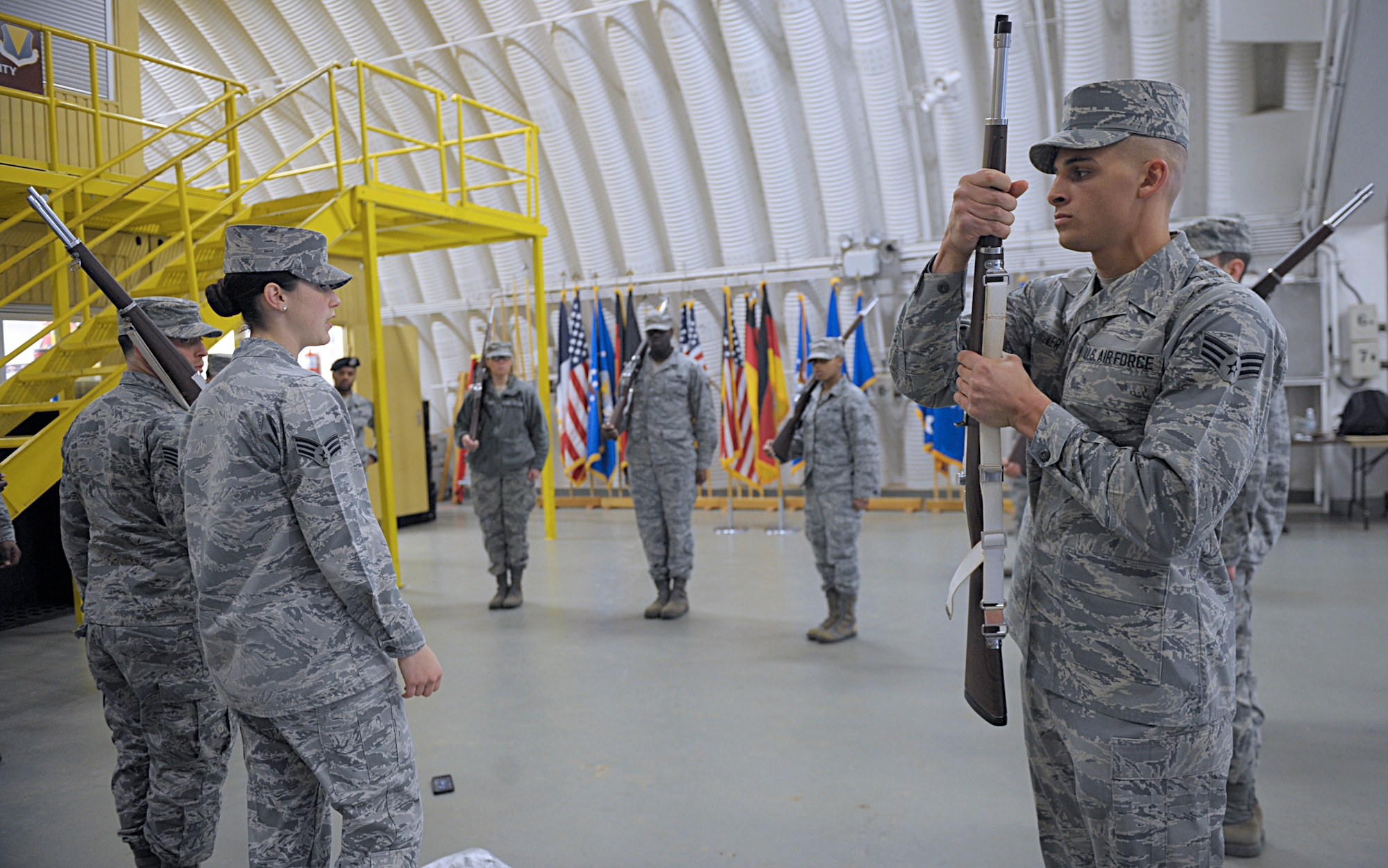 Senior Airman Angelo Hightower, U.S. Air Force Honor Guard Drill Team member, demonstrates the motions to perform right shoulder March 15, 2016, at Ramstein Air Base, Germany. Ramstein Honor Guard members got the opportunity to learn uniform preparation and color guard motions from U.S. Air Force Honor Guard members. (U.S. Air Force photo/Staff Sgt. Timothy Moore)