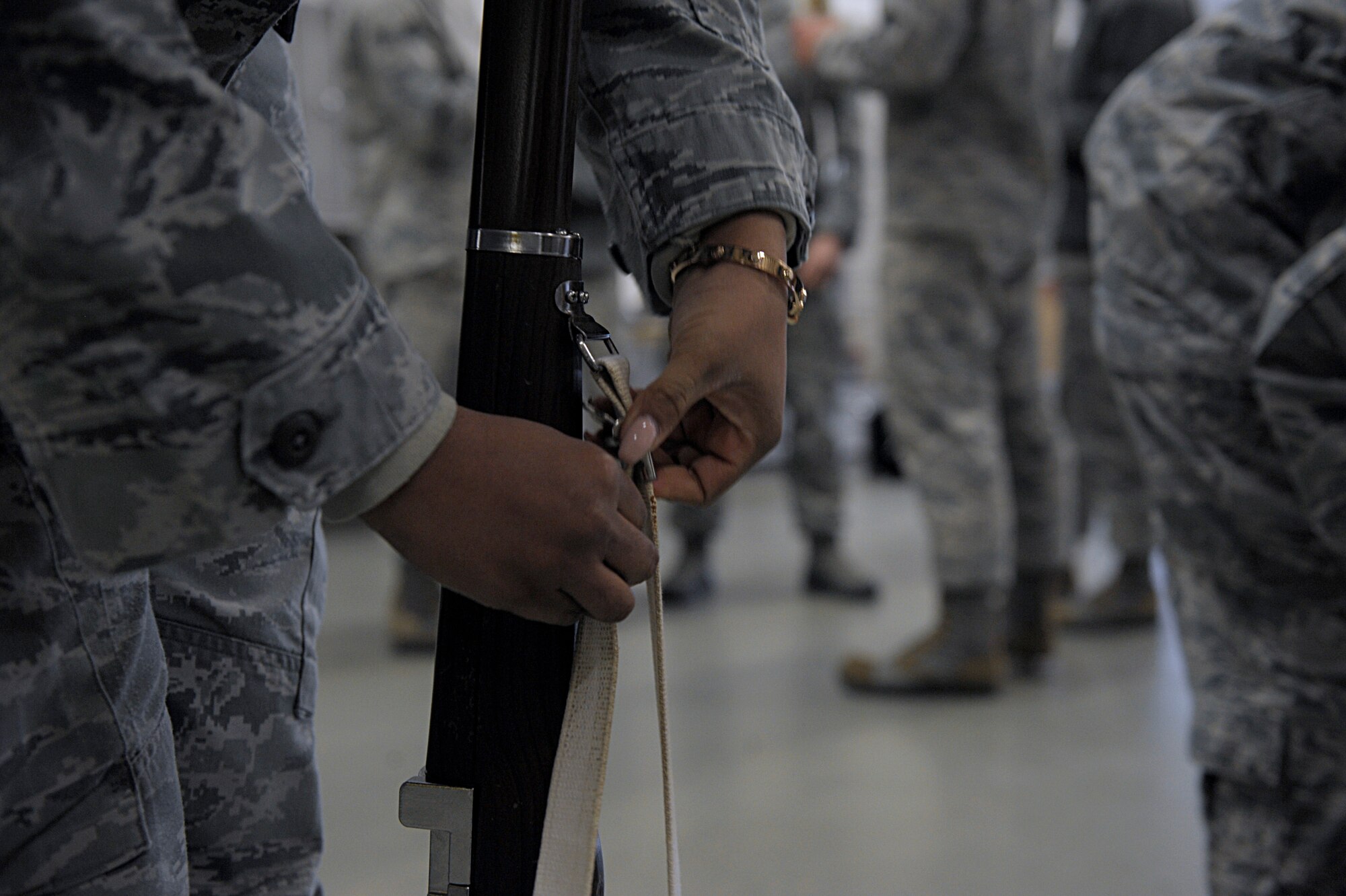 Senior Airman Angela Sams, 21st Operational Weather Squadron weather forecaster, secures a strap to a ceremonial rifle March 15, 2016, at Ramstein Air Base, Germany. Sams and other members of the Ramstein Honor Guard learned skills and techniques from U.S. Air Force Honor Guard members to become better honor guardsmen. (U.S. Air Force photo/Staff Sgt. Timothy Moore)
