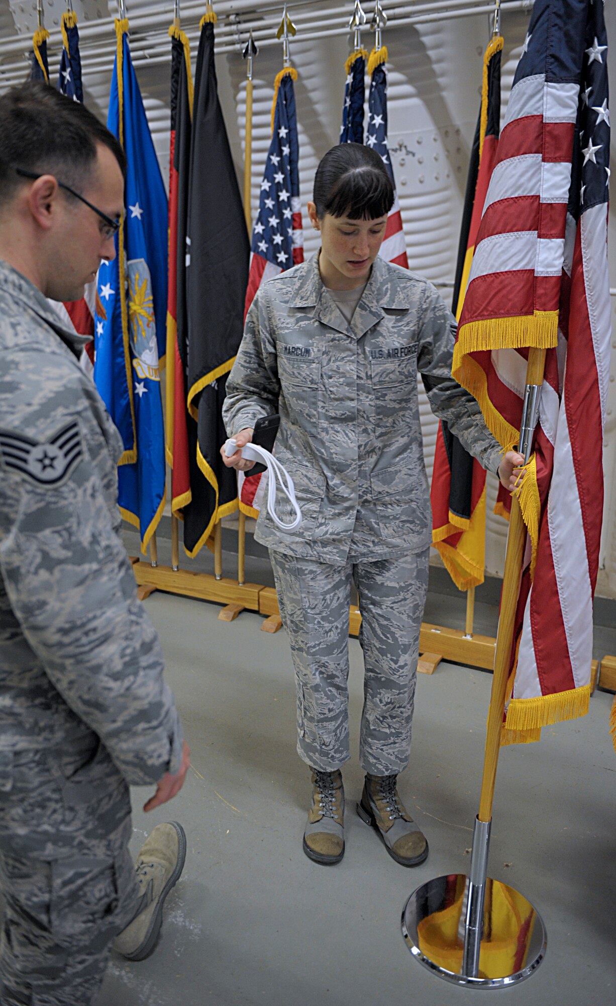 Senior Airman Amber Marcum, U.S. Air Force Honor Guard base honor guard program coordinator, discusses ways to display flags with Staff Sgt. Casey Chillemi, 86th Munitions Squadron munitions controller, March 15, 2016, at Ramstein Air Base, Germany. Chillemi and other members of the Ramstein Honor Guard learned skills and techniques from U.S. Air Force Honor Guard members to become better honor guardsmen. (U.S. Air Force photo/Staff Sgt. Timothy Moore)