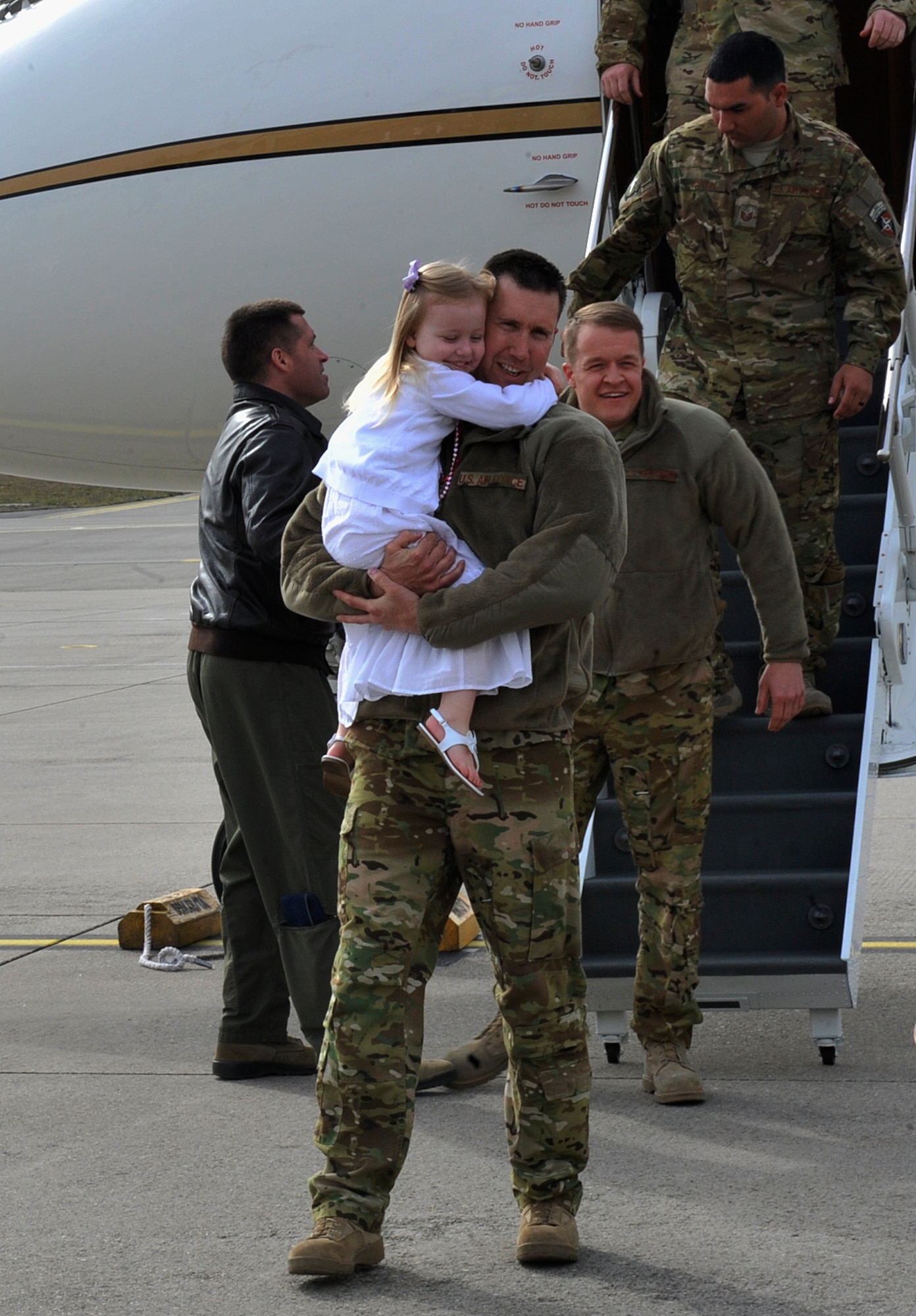 Airmen reunite with their families after returning from a deployment March 15, 2016, at Ramstein Air Base, Germany. The 76th Airlift Squadron Airmen aided an important mission by providing executive airlift and aeromedical evacuation. (U.S. Air Force photo/Airman 1st Class Larissa Greatwood)