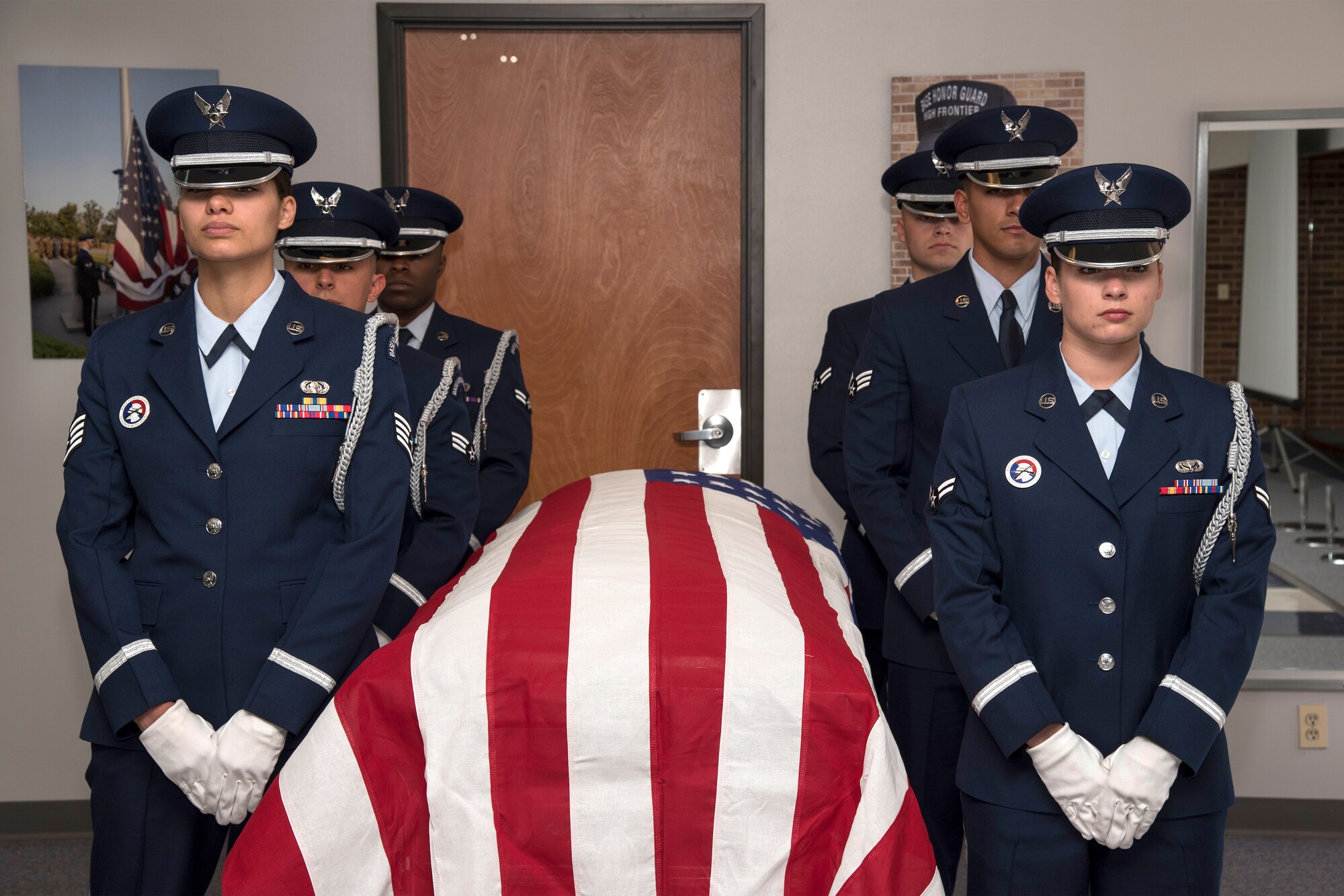 PETERSON AIR FORCE BASE, Colo. – (left front to back) Staff Sgt. Lindsay Frazier, 721st Communications Squadron, Senior Airman Darian Vidana, 50th Comptroller Squadron, Airman 1st Class Jordan Haynes, 50th Force Support Squadron, (right) Airman 1st Class Jennell Orsik, 21st Force Support Squadron, Senior Airman Joshua Gomez, 561st Network Operations Squadron and Senior Airman Sven Martinez, 21st Comptroller Squadron stand ready to perform the six-person flag fold at building 1465 here in preparation for a visit from Col. Douglas Schiess, 21st Space Wing commander March 14, 2016. The demonstration showcased the Honor Guard’s training, fitness, teamwork, precision and military bearing.  (U.S. Air Force Photo by Craig Denton)