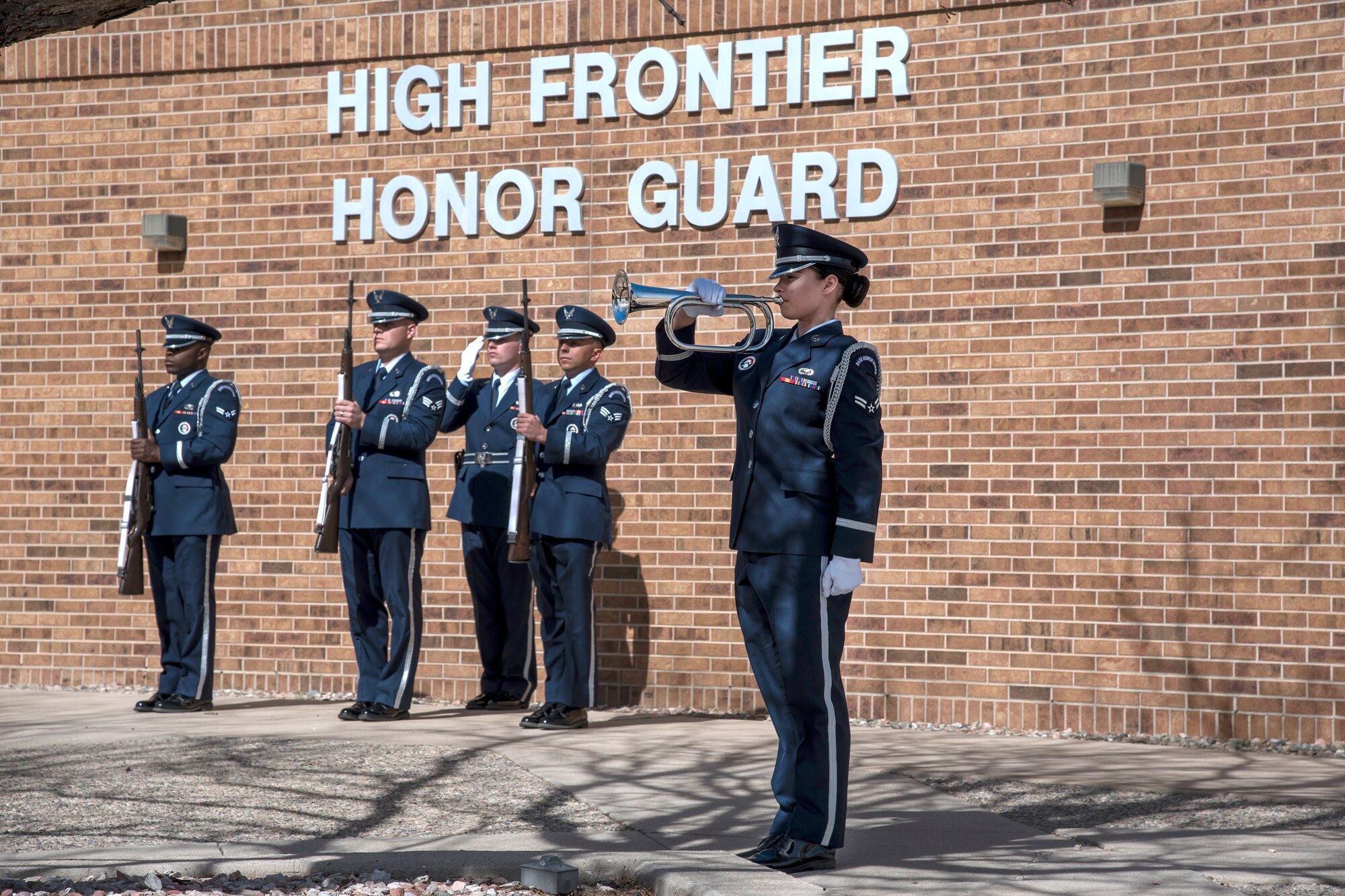 PETERSON AIR FORCE BASE, Colo. – Airman 1st Class Jennell Orsik, 21st Force Support Squadron, High Frontier Honor Guard plays the bugle during a firing party demonstration at building 1465 here for Col. Douglas Schiess, 21st Space Wing commander March 14, 2016. The demonstration showcased the Honor Guard’s training, fitness, teamwork, precision and military bearing.
(U.S. Air Force Photo by Craig Denton)

