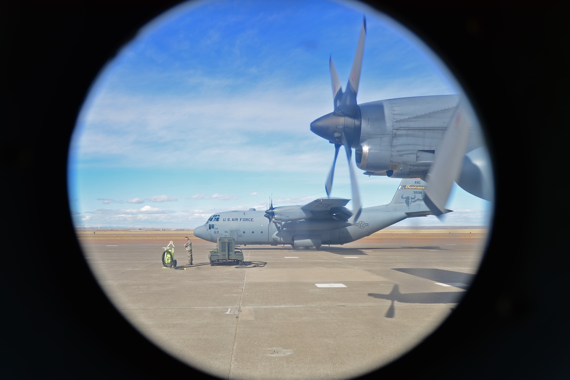 C-130s from the 186th Airlift Squadron of the Montana Air National Guard are inspected before departure March 5, 2016, in Great Falls, Mont. The MANG unit used the flight line at Malmstrom Air Force Base, Mont., for a training exercise to drop High Velocity Container Deliver System bundles as part of the required training to support war-time missions. (U.S. Air Force photo/Tech. Sgt. Patrick Mitchell)