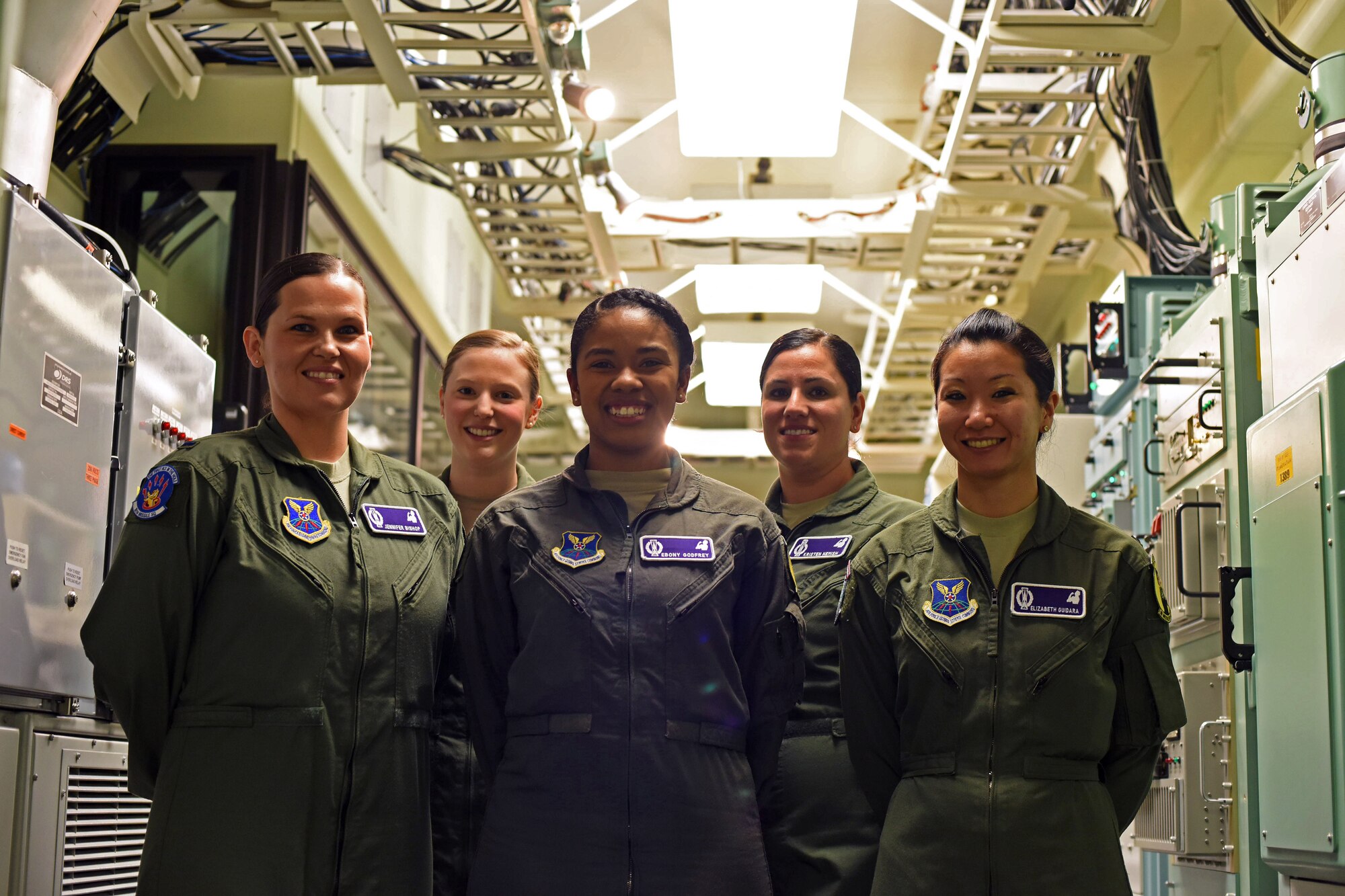 Missileers from Malmstrom Air Force Base, Mont., pose for a photograph after a training session at the missile procedures trainer March 21, 2016. Missile officers perform extensive training to ensure their ability to maintain quick response time and accurate input of essential data. (U.S. Air Force photo/Airman Collin Schmidt)