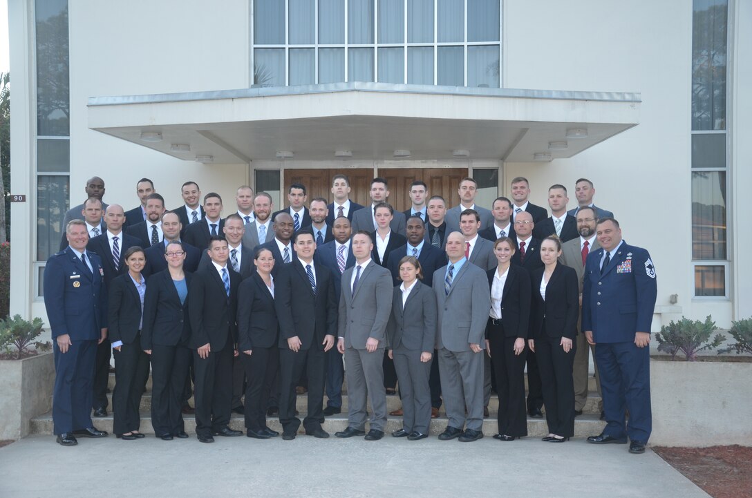 United States Air Force Special Investigations Academy Basic Special Investigators Course Class 16-02 joins USAFSIA Commander Col. Shan B. Nuckols, left, and Command Chief Master Sgt. Rob Redmon, right, commemorating the graduation of the academy's 15,000th Special Agent in this class March 24. (USAFSIA photo) 