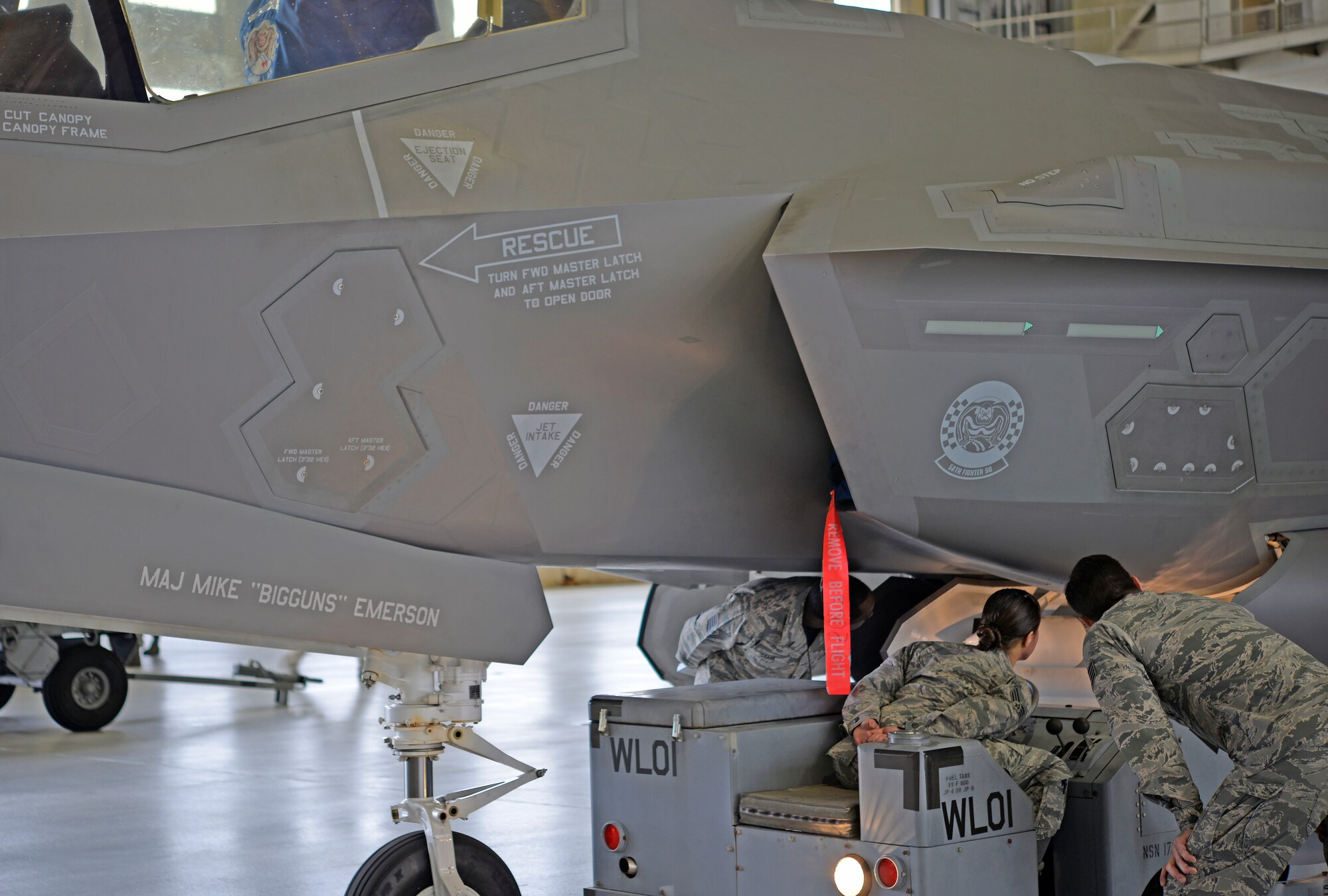 Load crew members from the 33rd Fighter Wing and judges watch as a weapon is loaded into an F-35A Lightning II during a weapons load competition at Eglin Air Force Base, Fla., March 18. This was the first weapons load competition here to face the 33rd FW and the 96th Test Wing against each other as they loaded weapons onto the F-35, F-15 Eagle and F-16 Fighting Falcon. During this competition, load crew teams were evaluated on the level of safety, efficiency and speed demonstrated while loading munitions. (U.S. Air Force photo/Staff Sgt. Tarelle Walker)