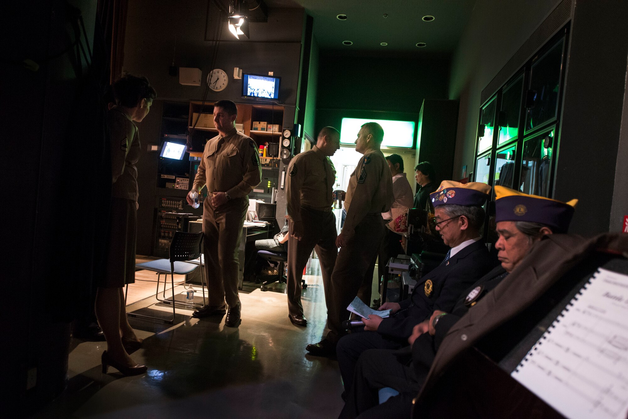 U.S. Air Force Band of the Pacific-Asia members prepare behind the scenes during an intermission at the Pallet Civic Theater March 14, 2016, in Naha, Japan. The Pacific Showcase brought the sights and sounds of big band jazz to Okinawa. (U.S. Air Force photo by Senior Airman Omari Bernard)