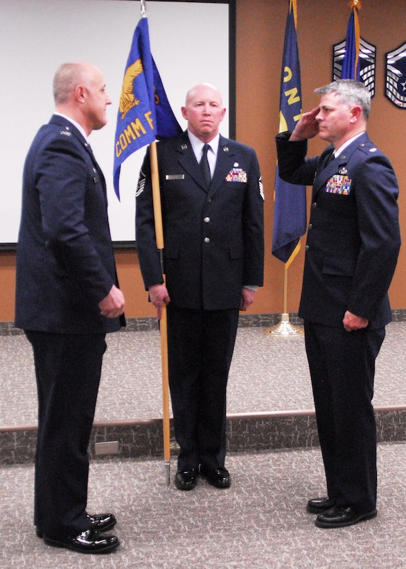 120th Communications Flight Commander Lt. Col. Timothy Lincoln salutes 120th Mission Support Group Commander Col. Frederyck Cayer, Jr. after assuming command. 120th Mission Support Group First Sergeant Master Sgt. Jason Grout holds the guidon March 5, 2016. (U.S. Air Force photo by Staff Sgt. Lindsey Soulsby)