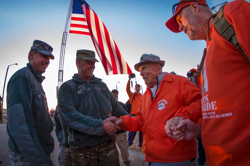 Army Brig. Gen. Timothy R. Coffin, center left, commander of White Sands Missile Range, greets retired Army Col. Ben Skardon, a survivor of the Bataan Death March, before the start of the Bataan Memorial Death March, March 20, 2016. Army photo by Staff Sgt. Ken Scar