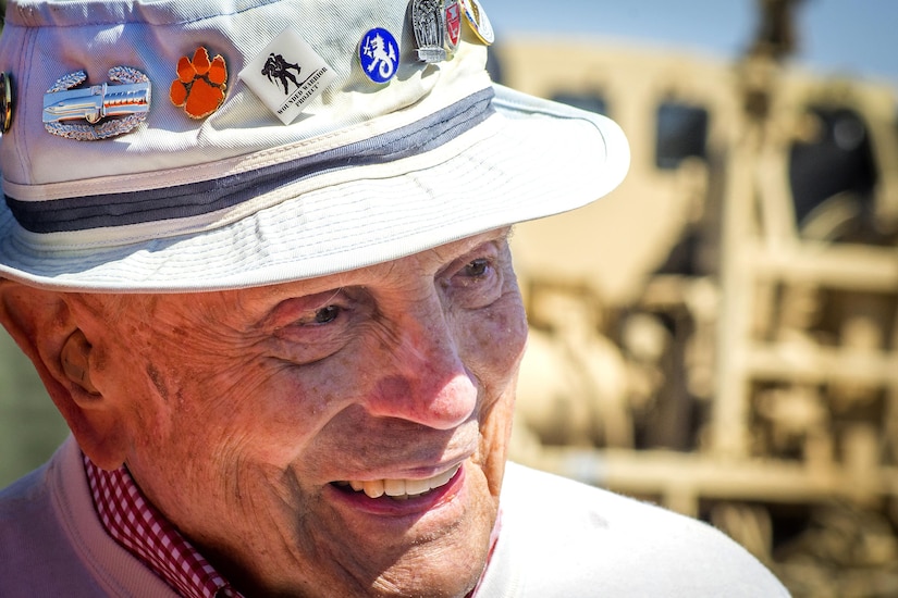 Retired Army Col. Ben Skardon, a survivor of the Bataan Death March, talks with a group of supporters after walking more than eight miles in the Bataan Memorial Death March at the White Sands Missile Range, N.M., March 20, 2016. Army photo by Staff Sgt. Ken Scar