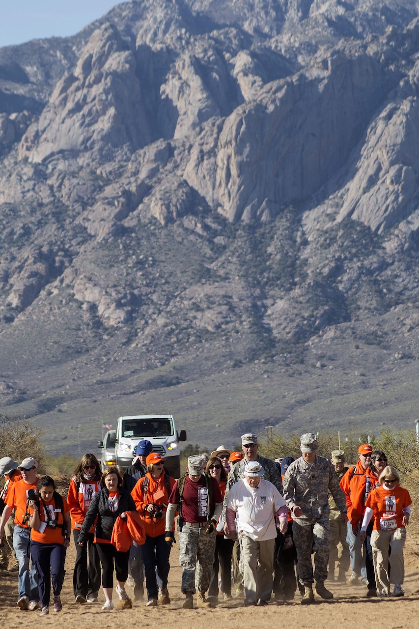Retired Army Col. Ben Skardon, in white shirt, walks with the “Ben’s Brigade”, a group of his supporters, during the Bataan Memorial Death March at White Sands Missile Range, N.M., March 20, 2016. Skardon is a survivor of the Bataan Death March and is the only survivor who walks in the memorial march. This is the ninth year in a row he has done so. Army photo by Staff Sgt. Ken Scar