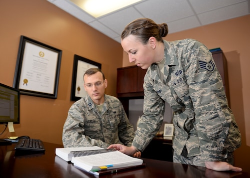 Capt. Samuel Jordan, Special Victims’ Counsel attorney, and Staff Sgt. Lauren Harris, SVC paralegal, work together as a part of the SVC Program at Minot Air Force Base, N.D., Feb. 1, 2016. The SVC helps sexual assault survivors not only navigate the military justice process, but also helps them find healing and take back control of their lives. (U.S. Air Force photo/Airman 1st Class J.T. Armstrong)